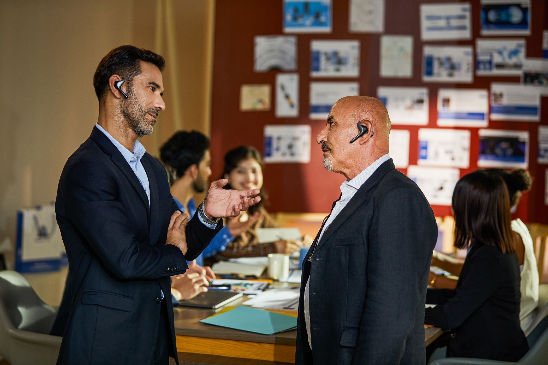 Two Colleagues Conversing Using the W4 Pro Earbuds