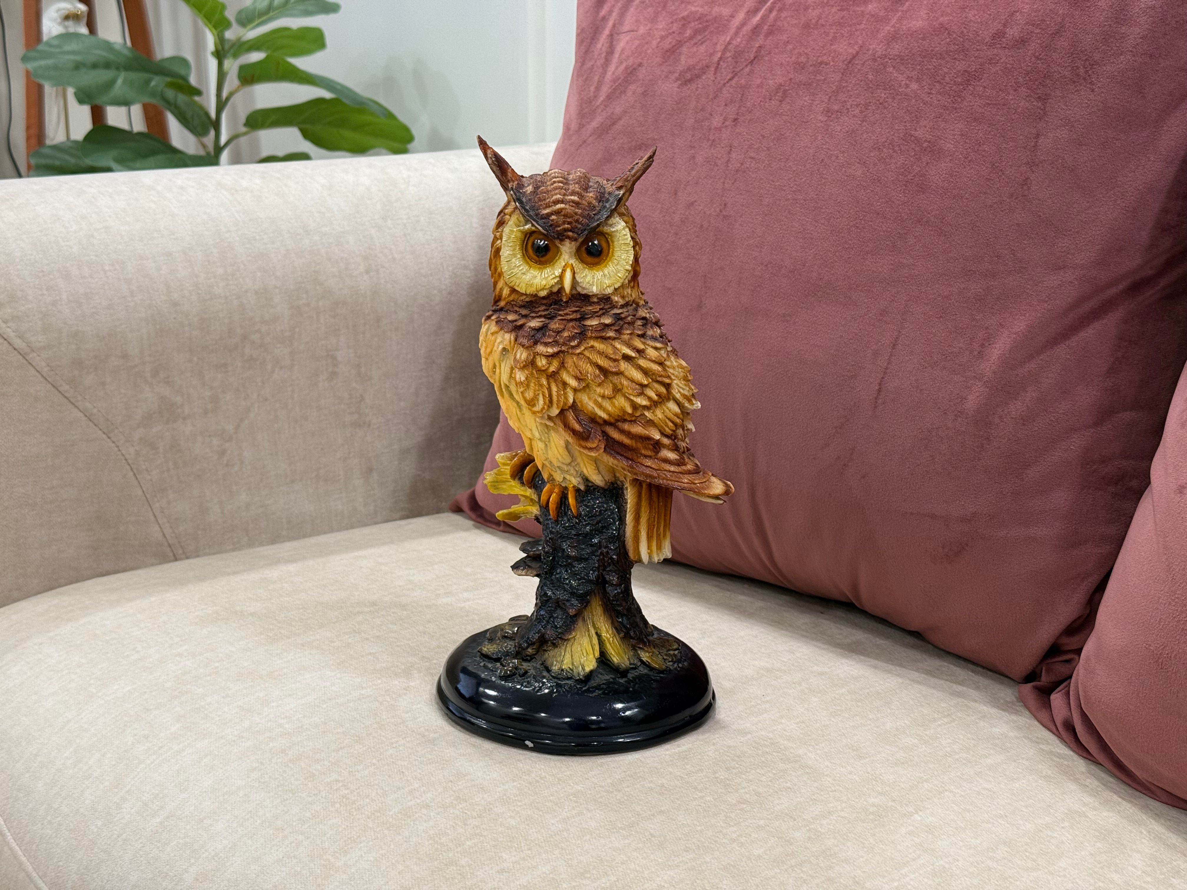 Decorative owl statue on a white sofa