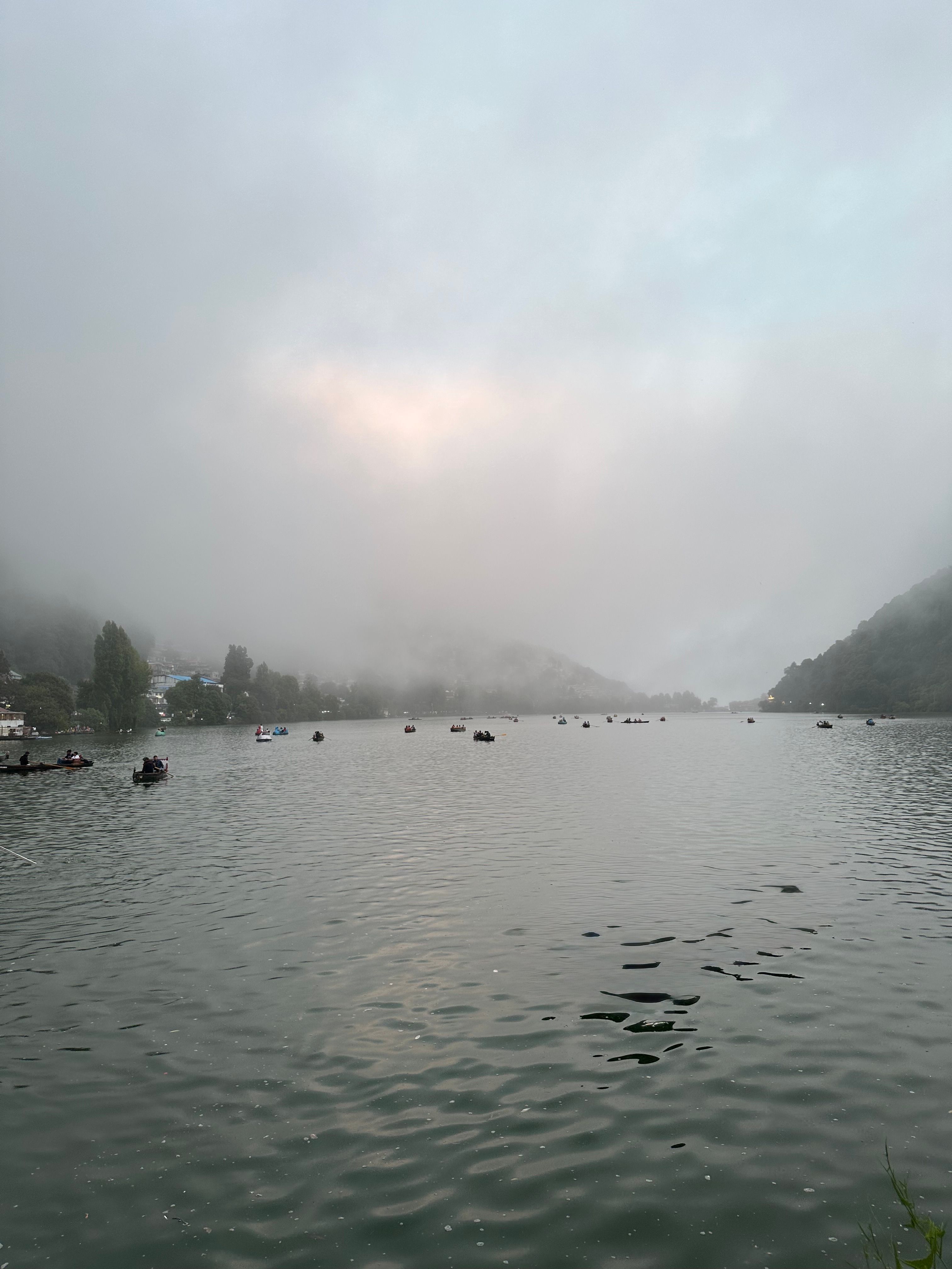 Serene lake view with boat in front removed on iPhone 16 Pro