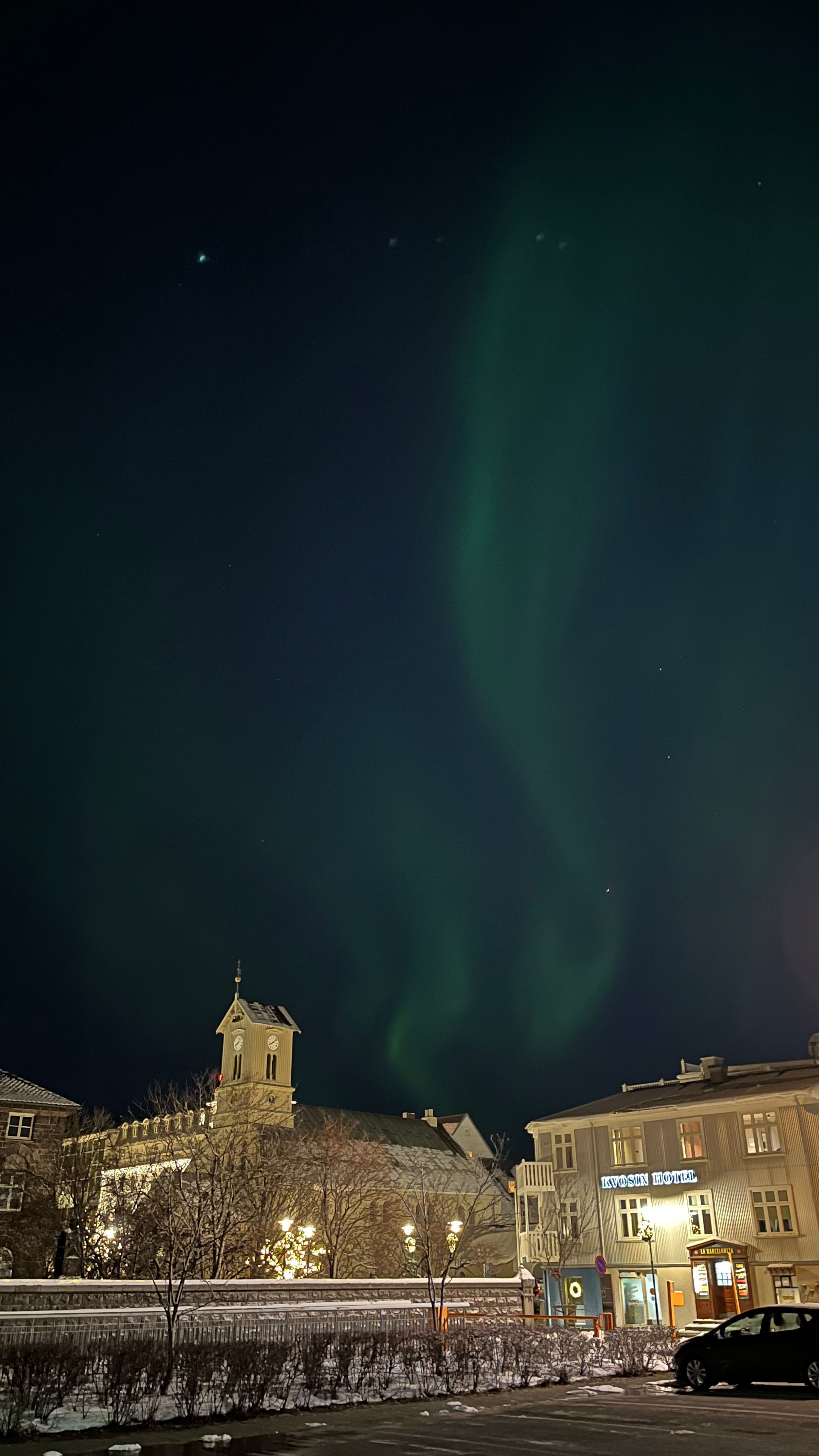 An image showing the Northern Lights in a city 