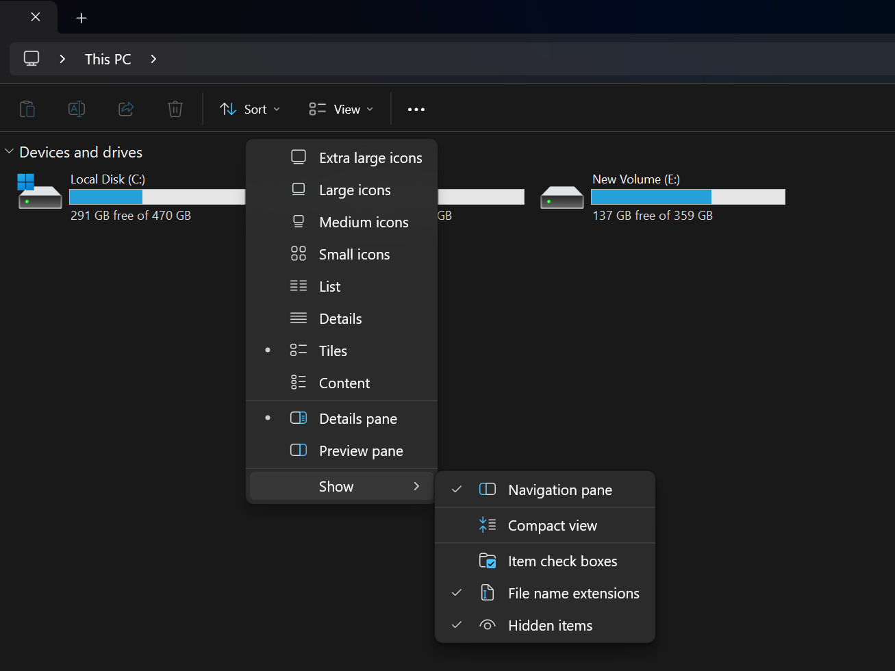View menu showing file name extensions enabled with partitions in the background.