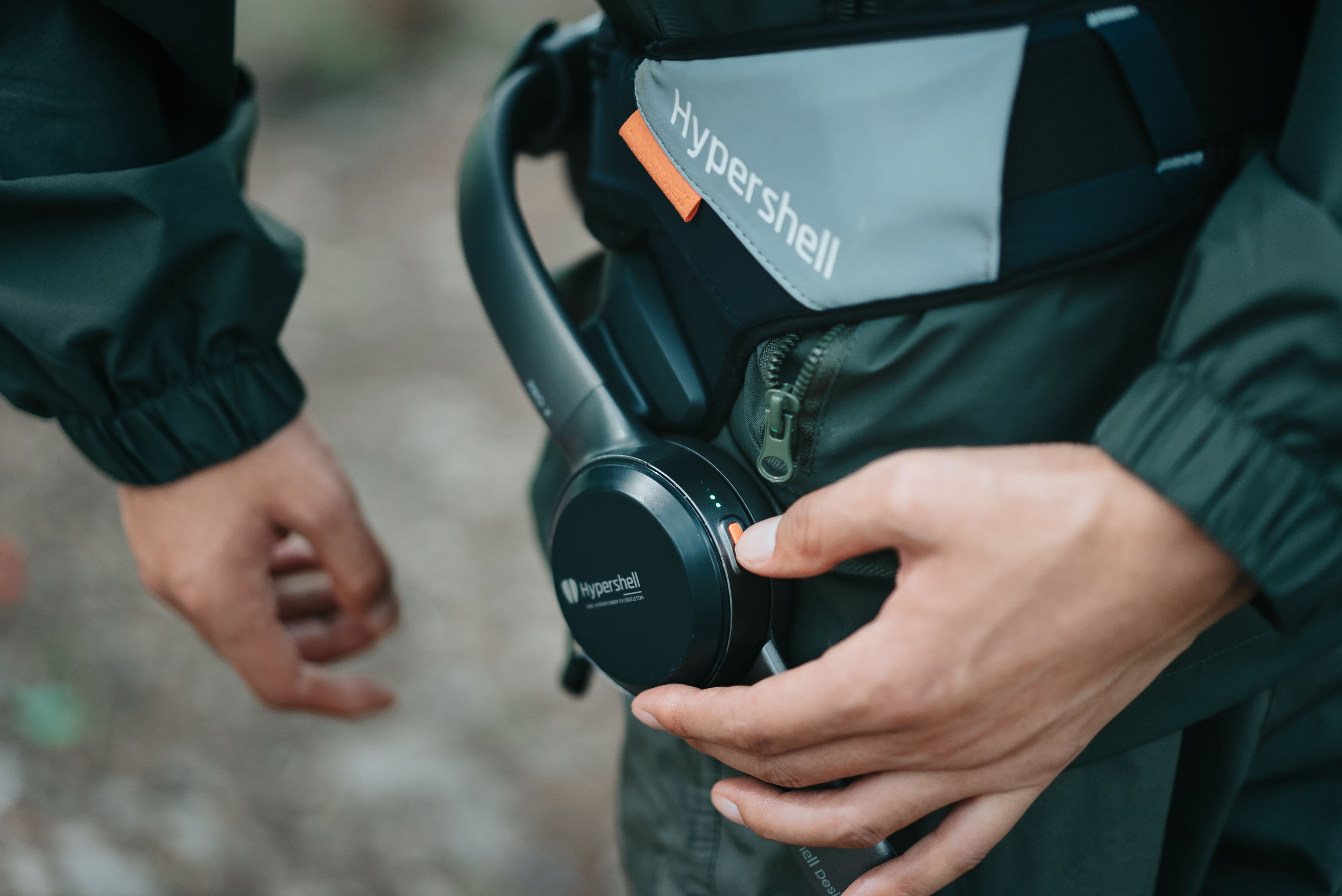 A person operates the controls of a Hypershell exoskeleton.