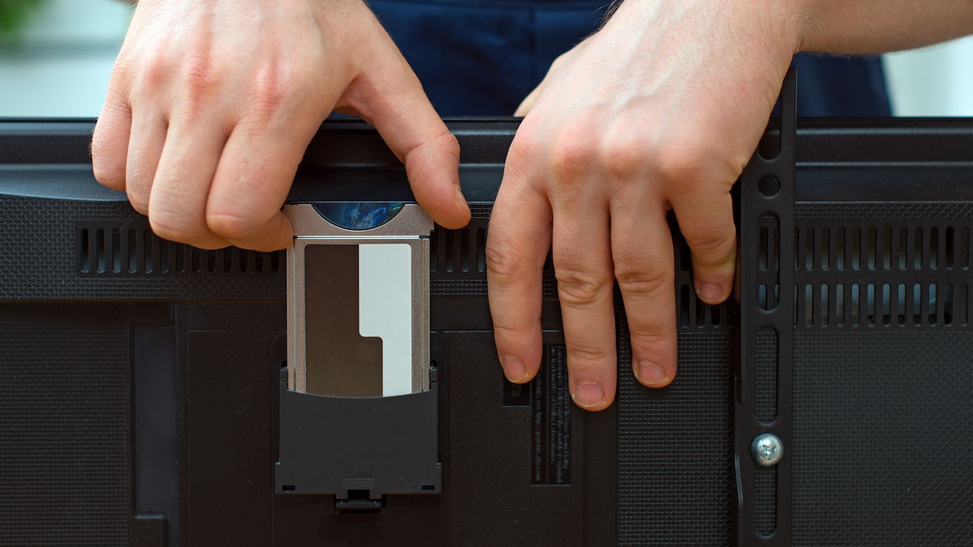 Man installing conditional access module card