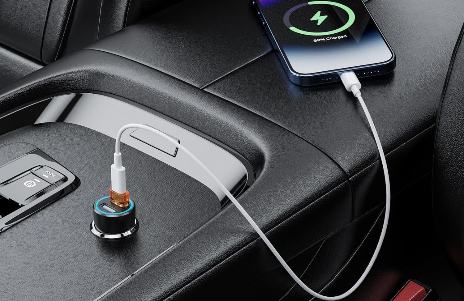 A smartphone charges in a car using a USB-C cable connected through a USB to USB-C adapter plugged into the car's USB port.