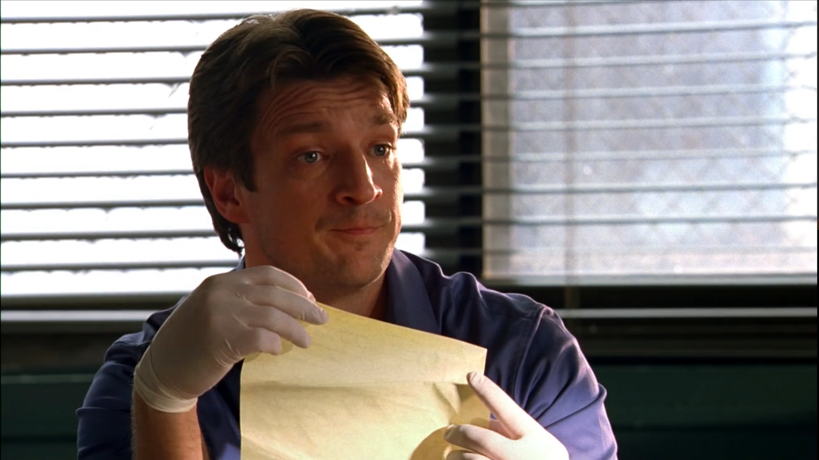 Castle holding a piece of paper and looking perplexed