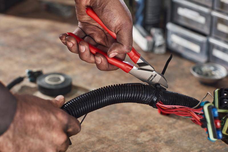 Pliers being used to cut a wire