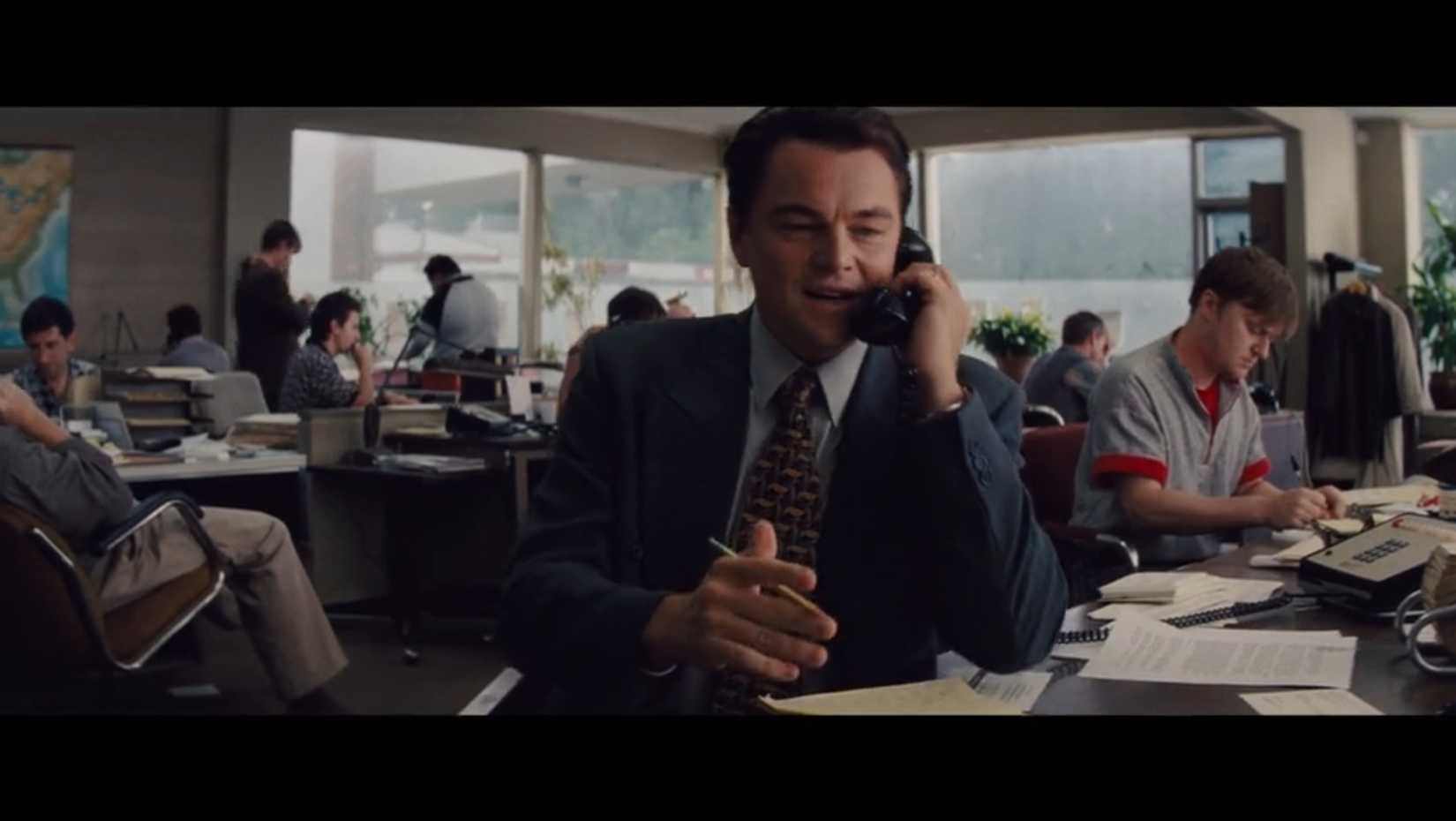 Leonardo DiCaprio talking on the phone and waving his hand