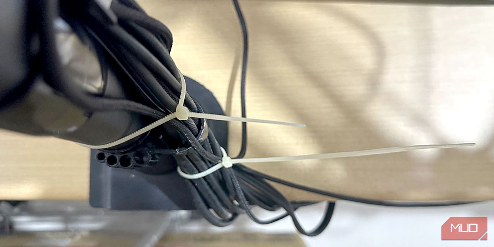 Plastic cable ties on a monitor arm
