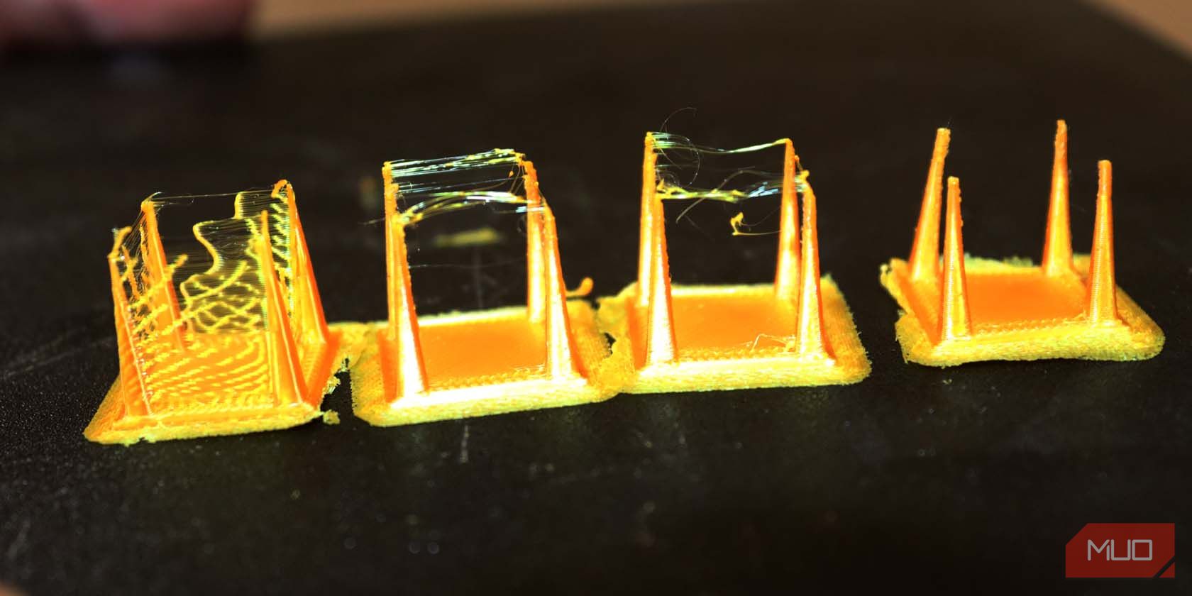 Several 3d prints covered with strings and one without
