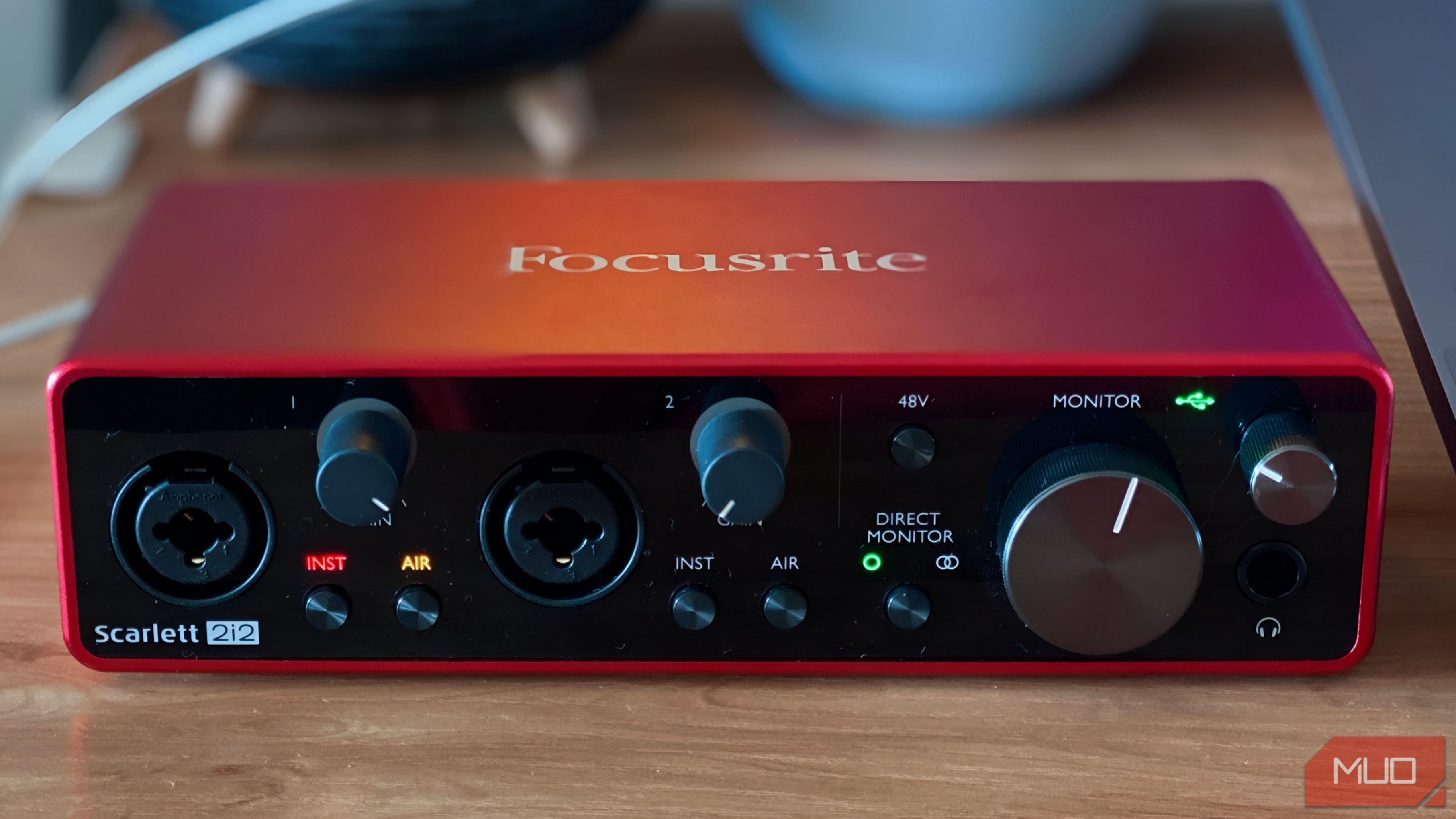 Focusrite Scarlett 2i2 on wooden table with power on