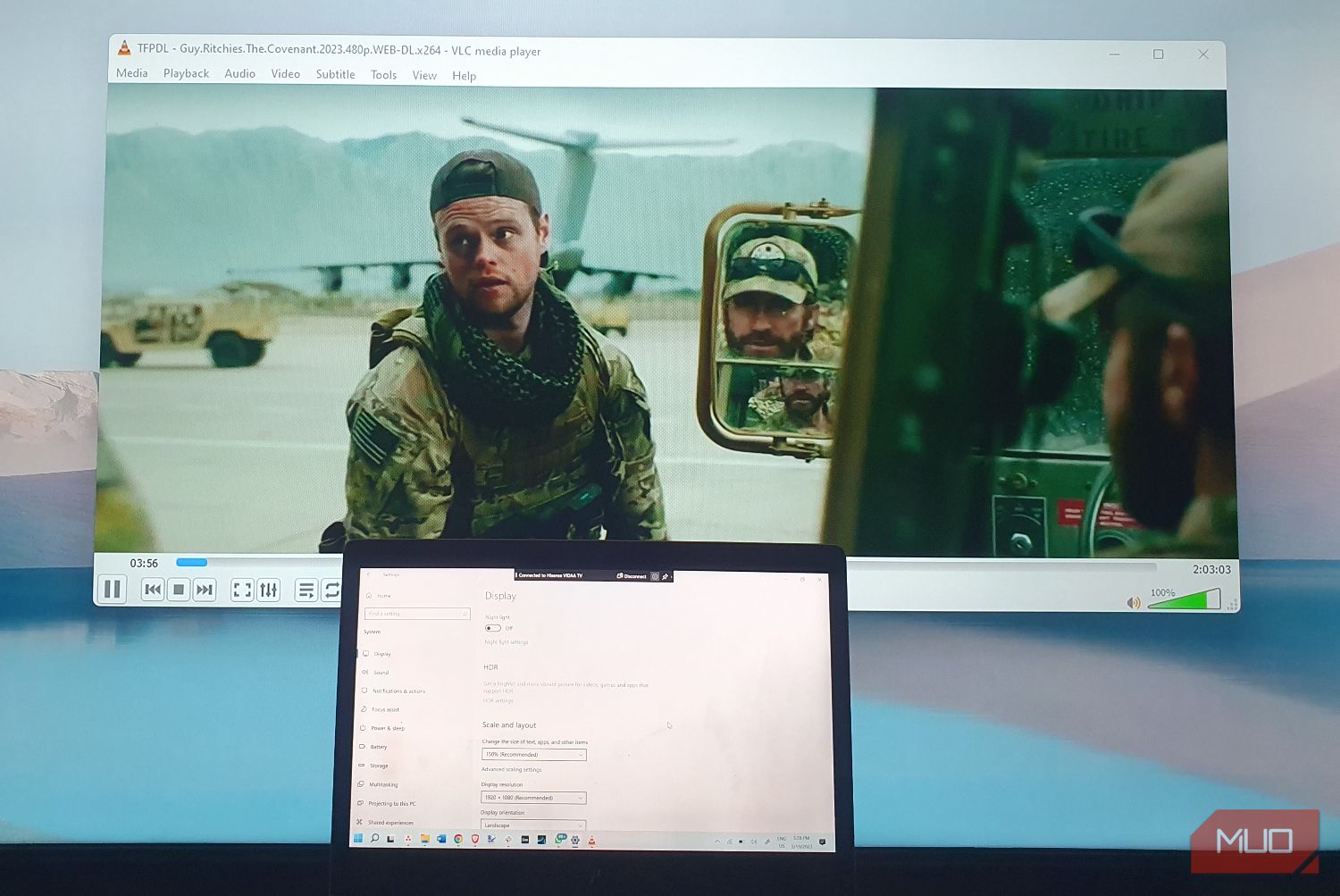 A laptop casting a movie onto a monitor
