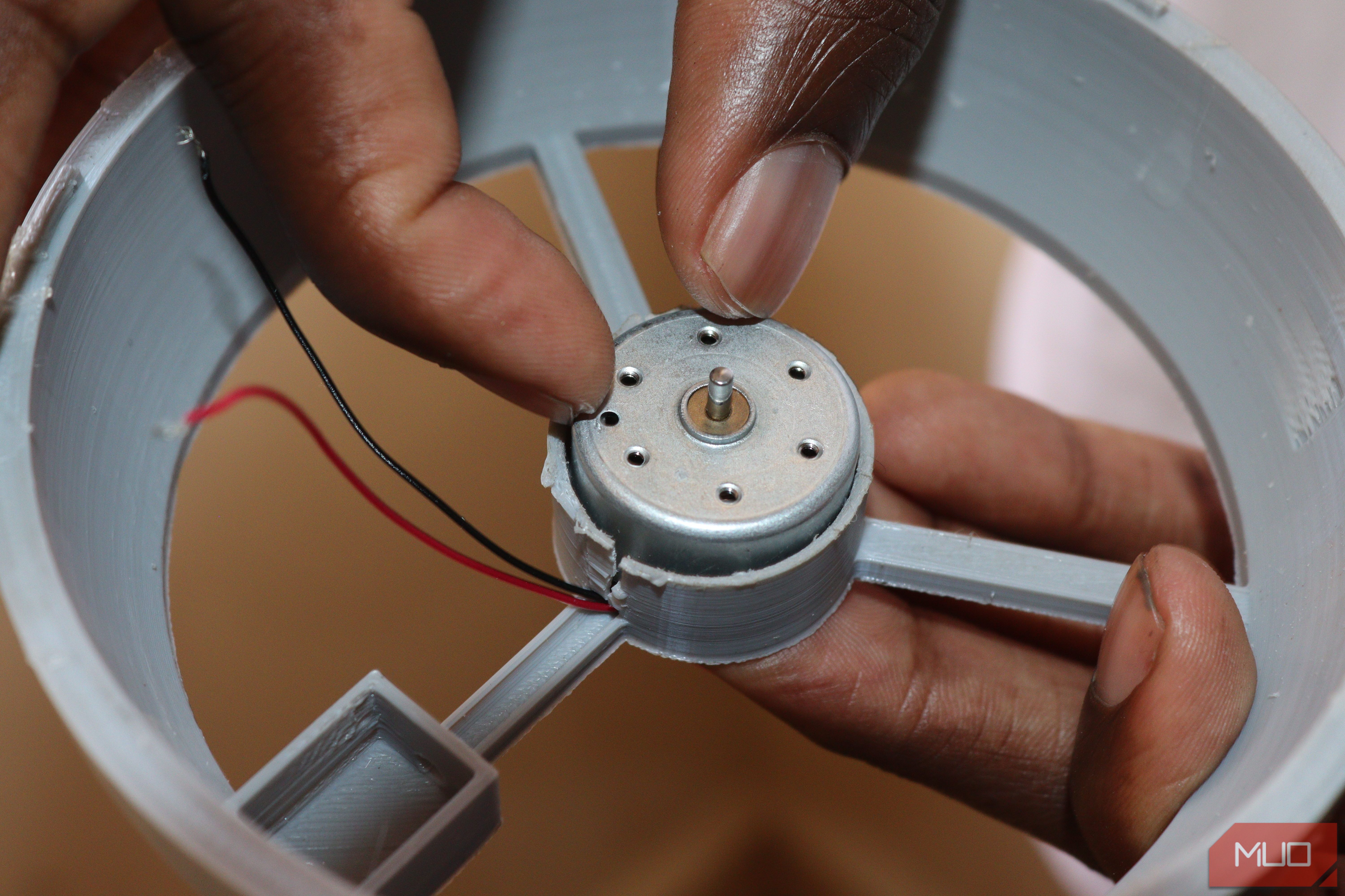 Placing the motor inside the casing of the fan