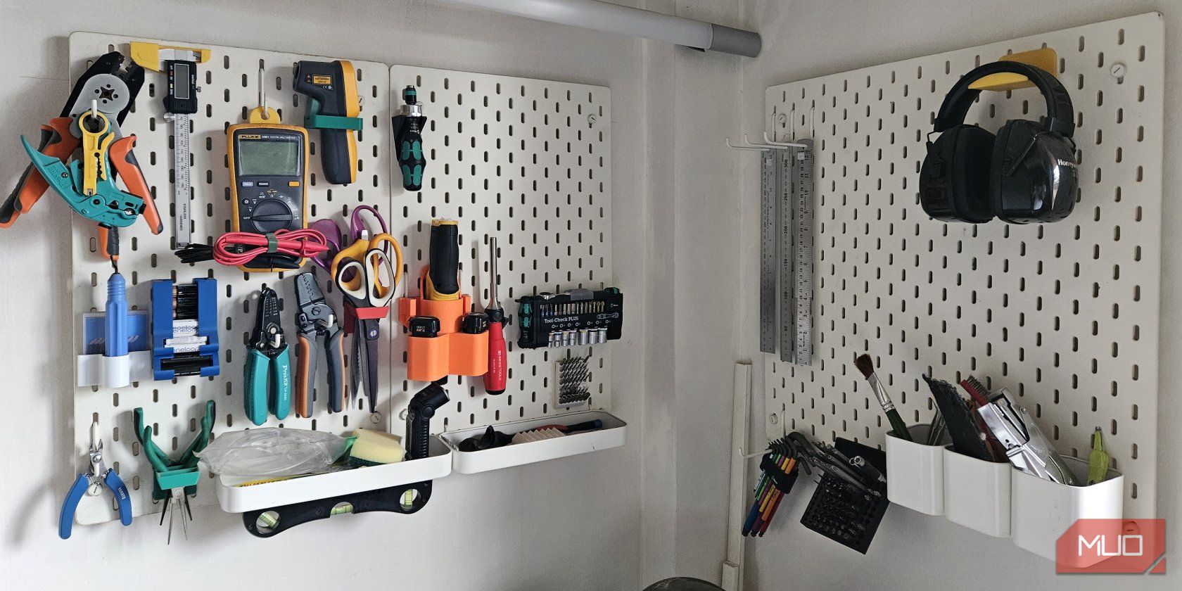 Two IKEA pegboards with several tools mounted onto custom accessories.