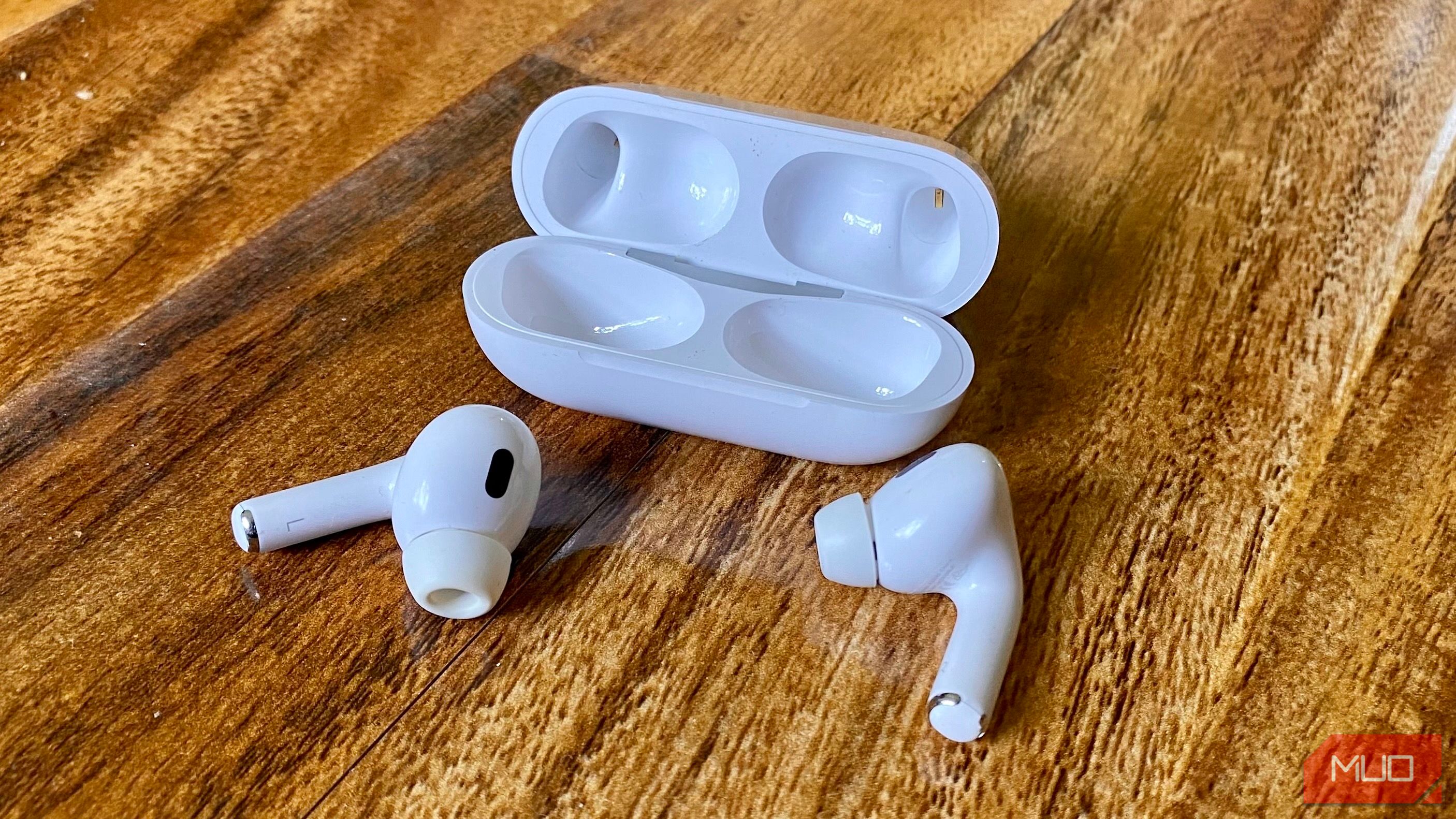 image of airpods on wooden table
