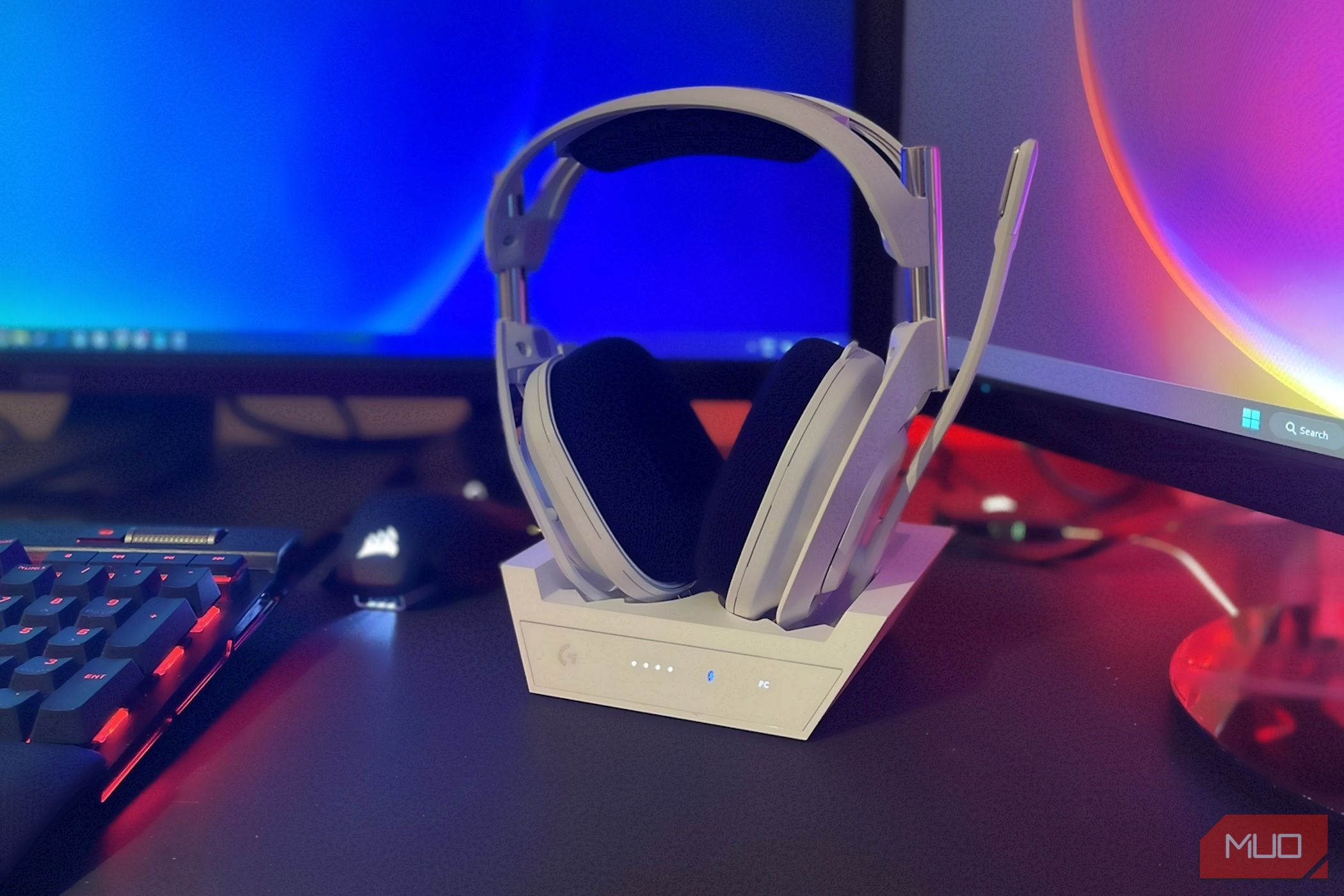 astro a50 x headset on base station next to monitors