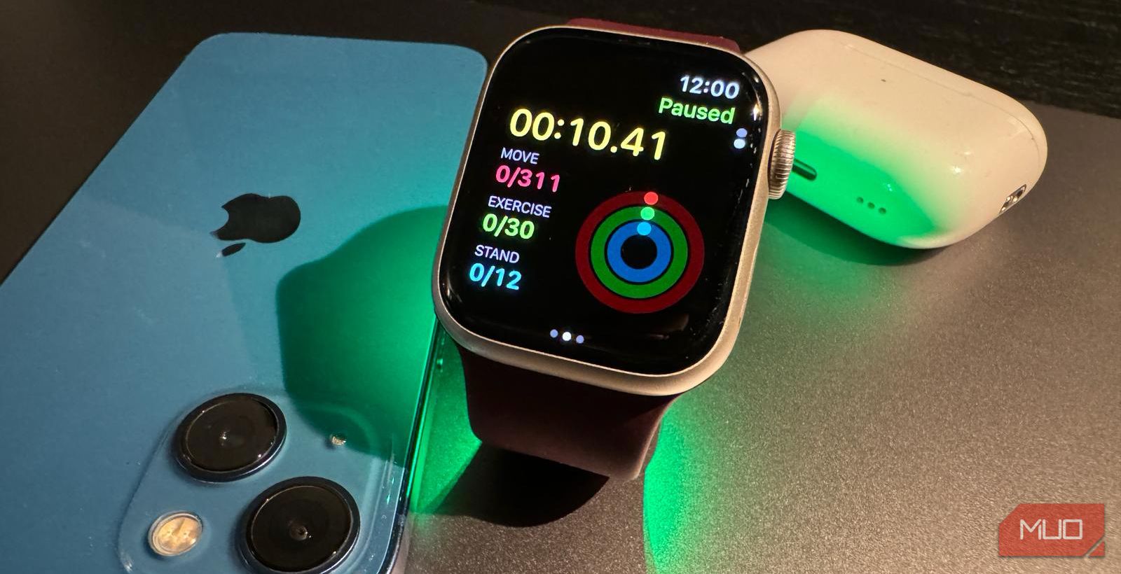 Apple Watch Series 9 currently engaged in a workout session, with an iPhone and AirPods Pro in the background.