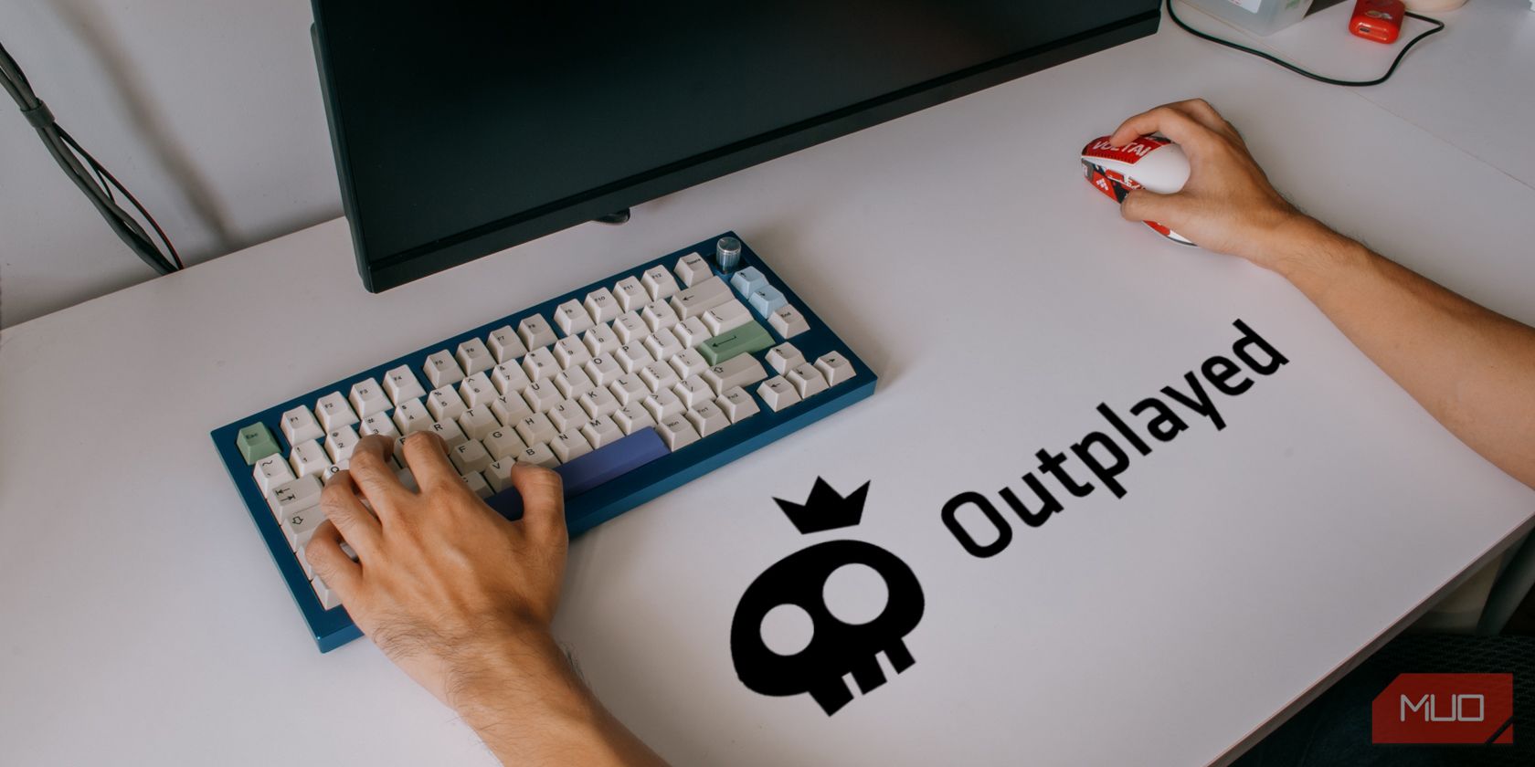 Outplayed logo on desk with mouse and keyboard