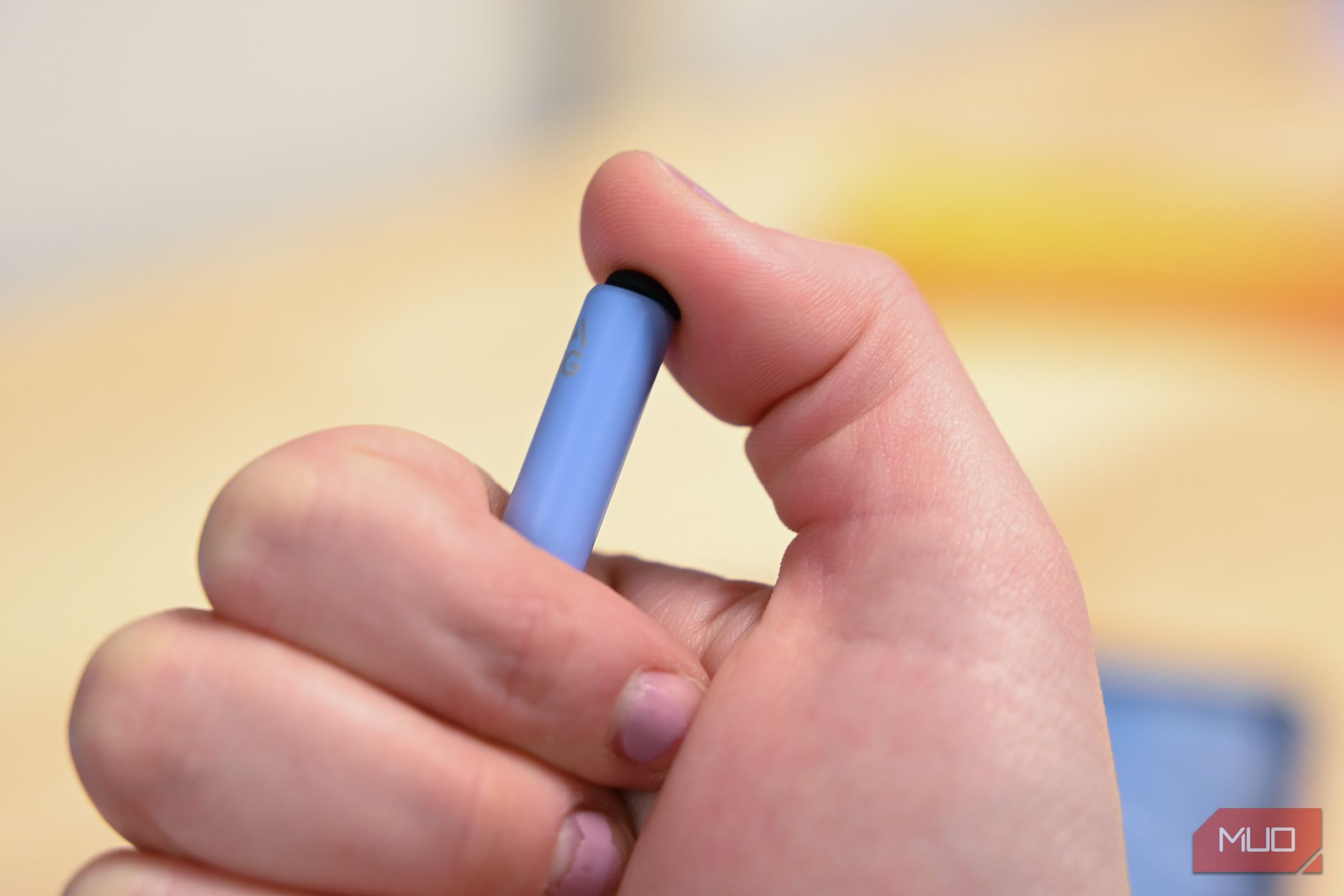 Person pressing the button on the ZAGG Pro Stylus 2