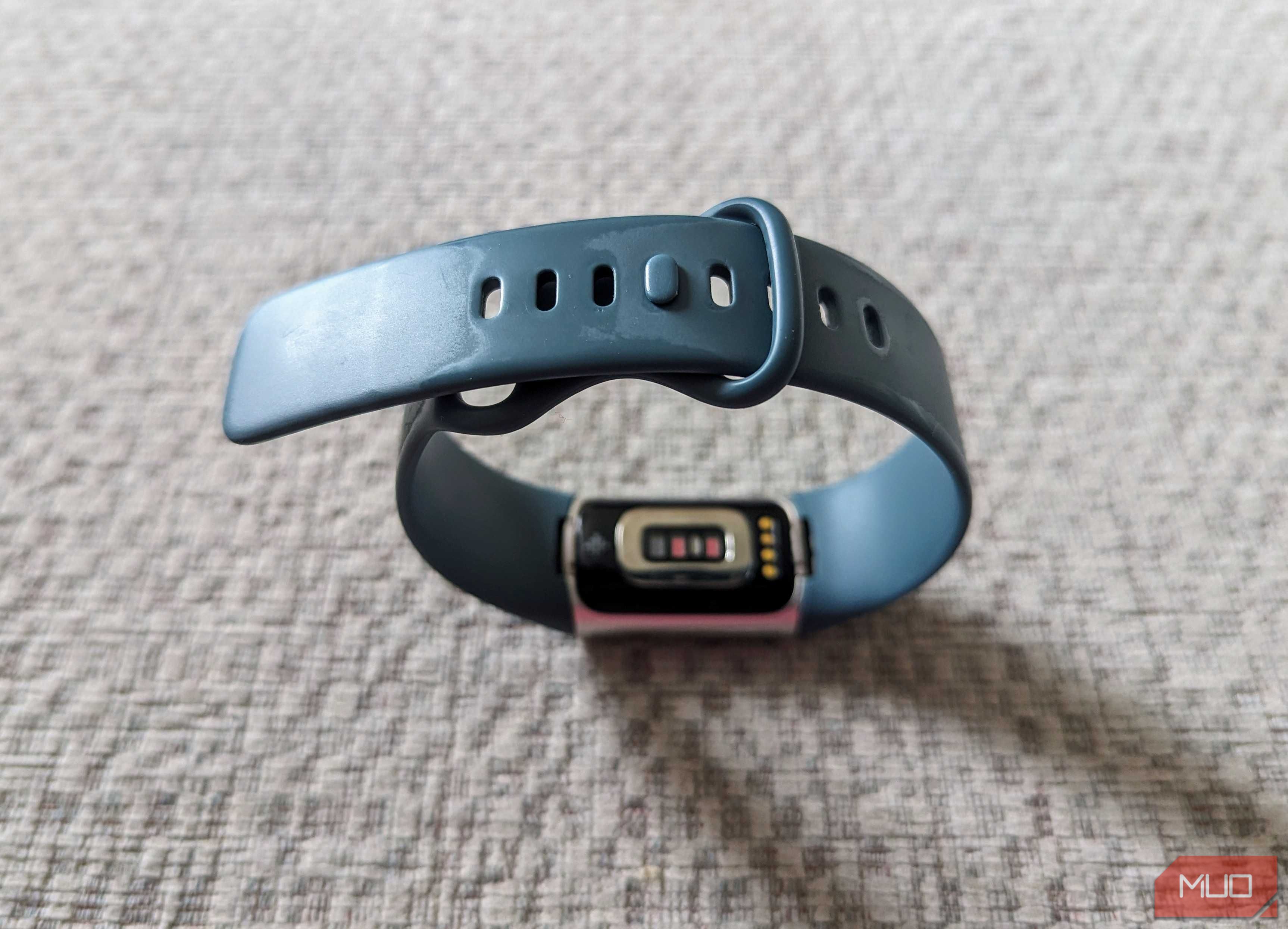 A Fitbit with its original band in focus