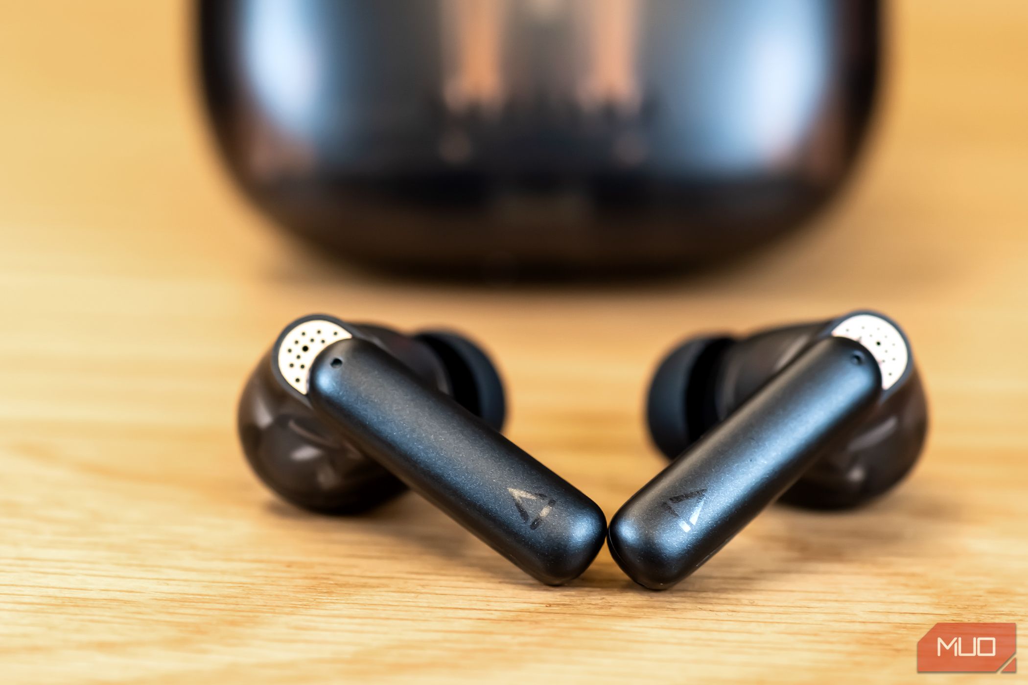 The Creative Aurvana Ace 2 earbuds in front of their case