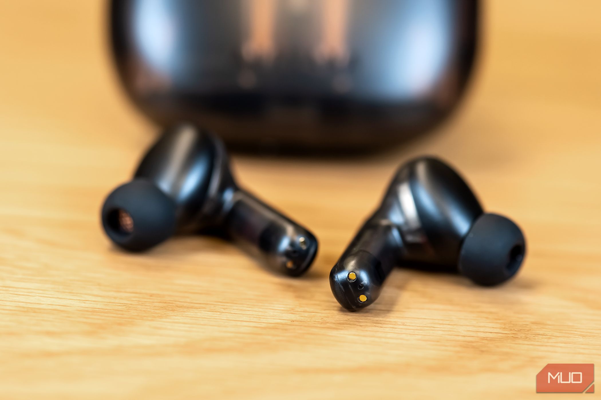The Creative Aurvana Ace 2 earbuds in front of their case