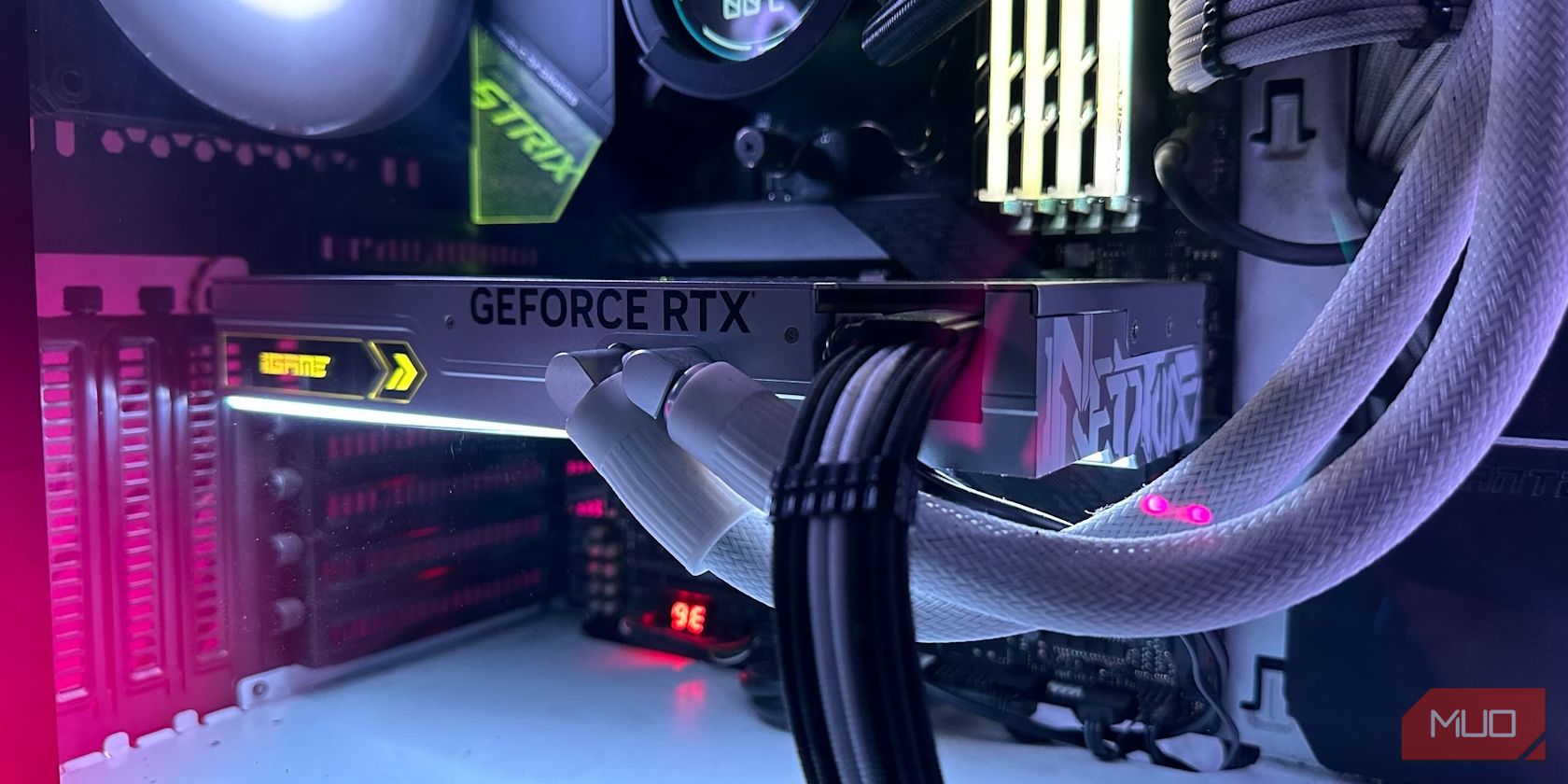A white liquid-cooled GeForce RTX 4090 graphics card inside a PC Case
