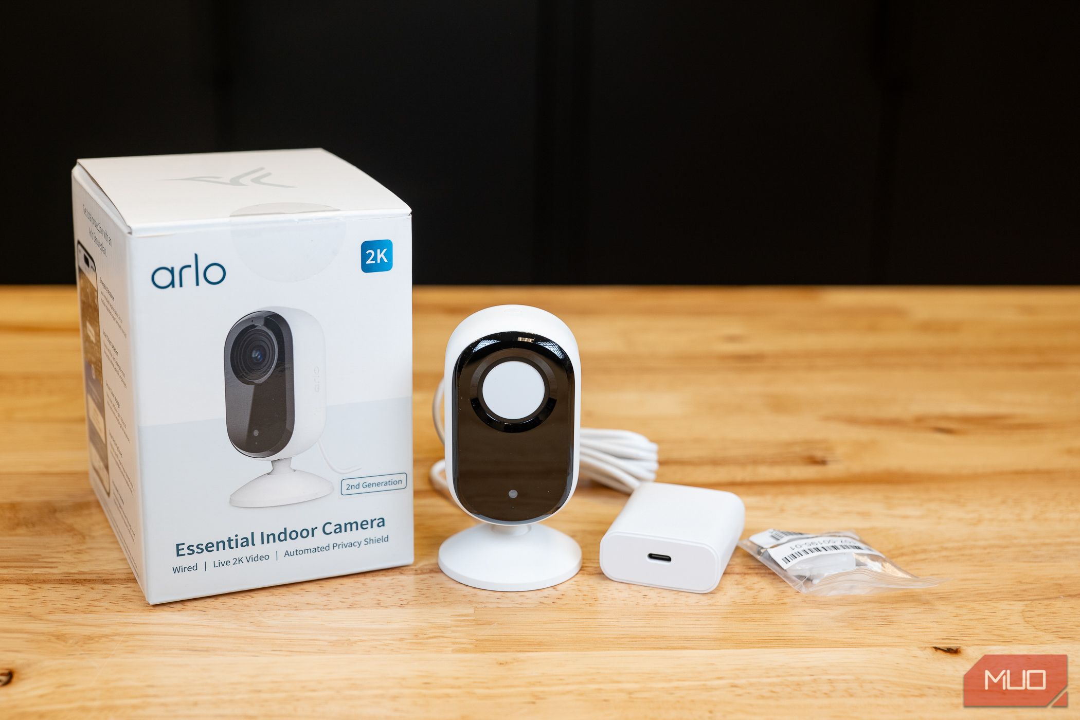 Arlo Essential Indoor Camera next to box with power brick and mounting kit