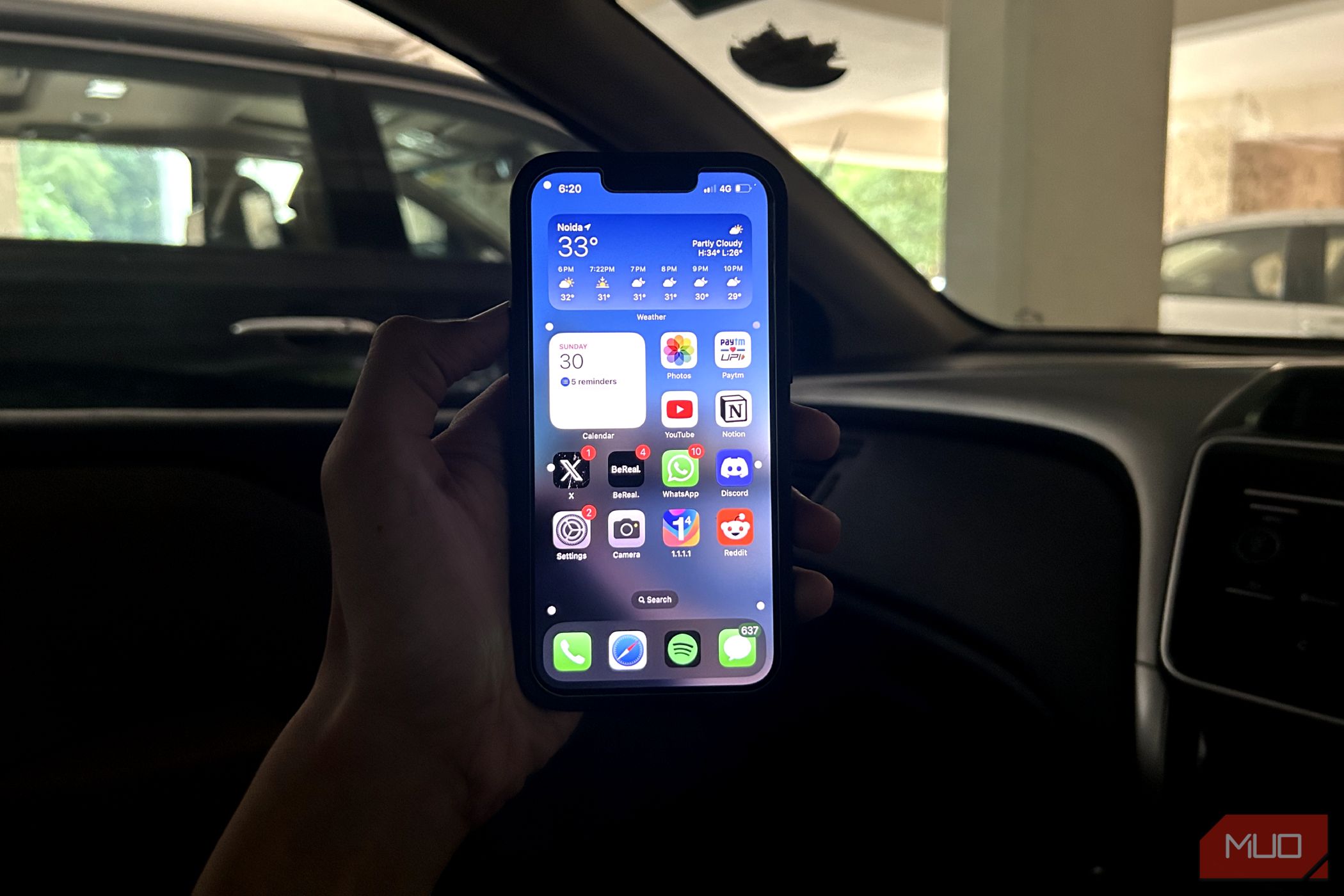 a man holding an iPhone inside a car with Vehicle Motion Cues turned on