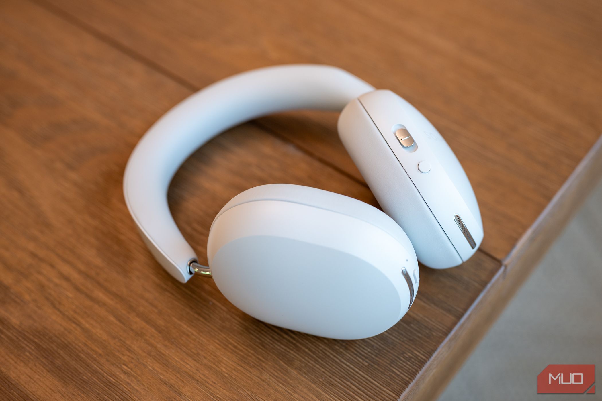Sonos Ace headphones sitting on a table showing microphone grills, buttons, and USB-C port-1