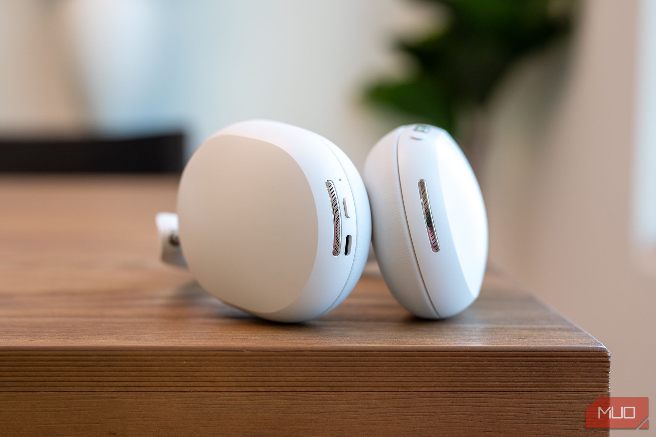 Sonos Ace headphones sitting on a table showing microphone grills, buttons, and USB-C port