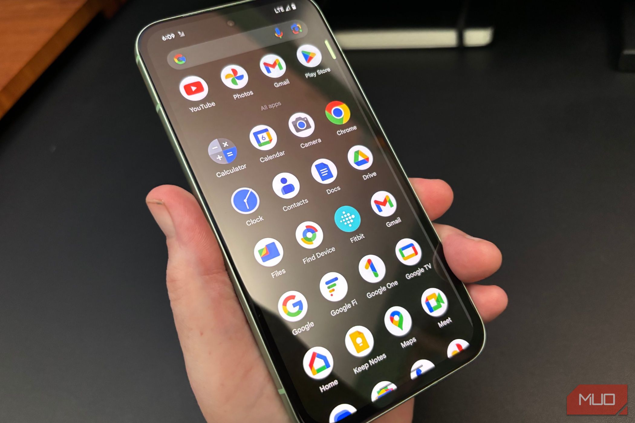 Person holding the Google Pixel 8a showing the apps menu