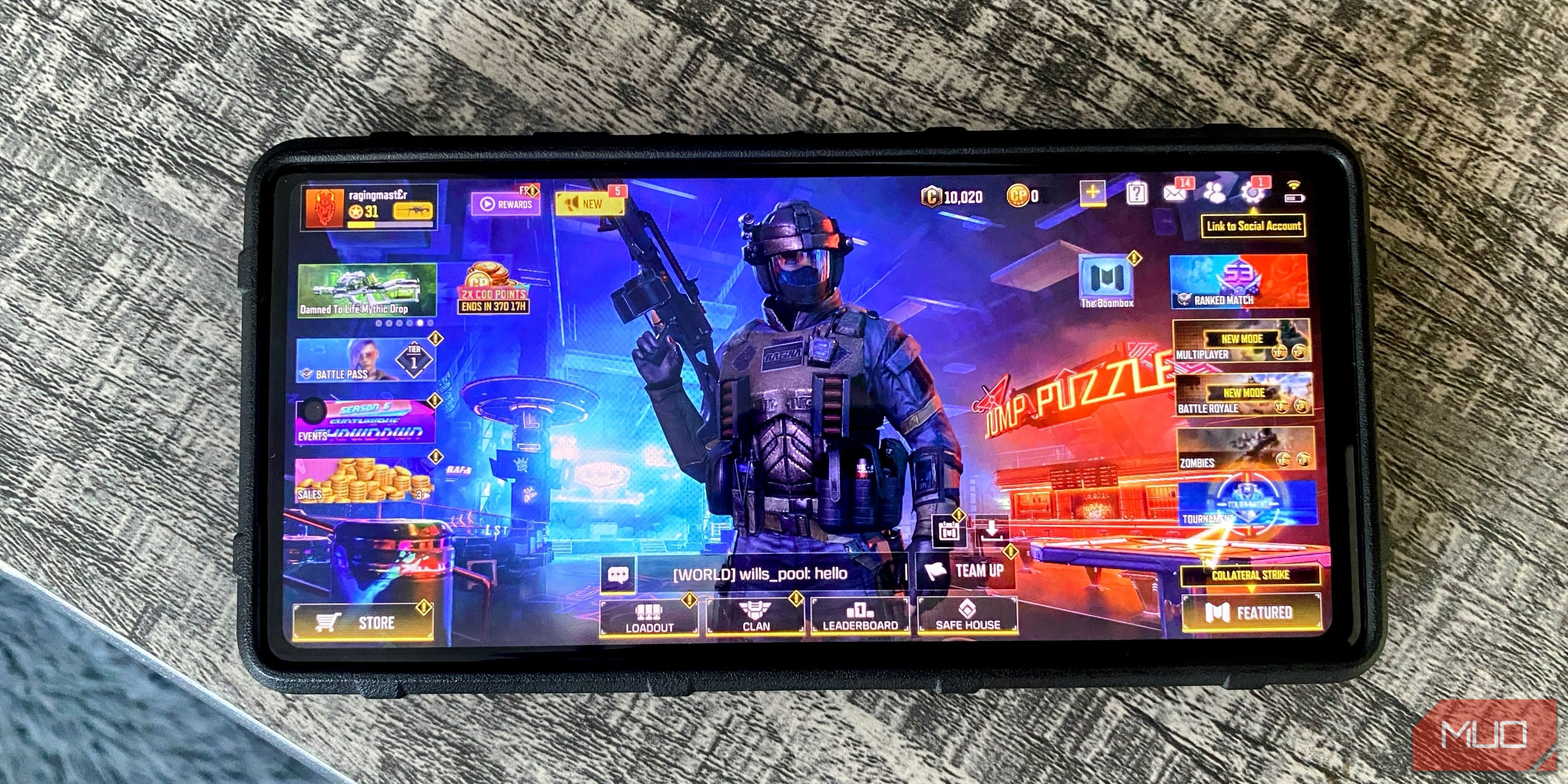 Android phone on a table top with Call of Duty Mobile game home screen displayed