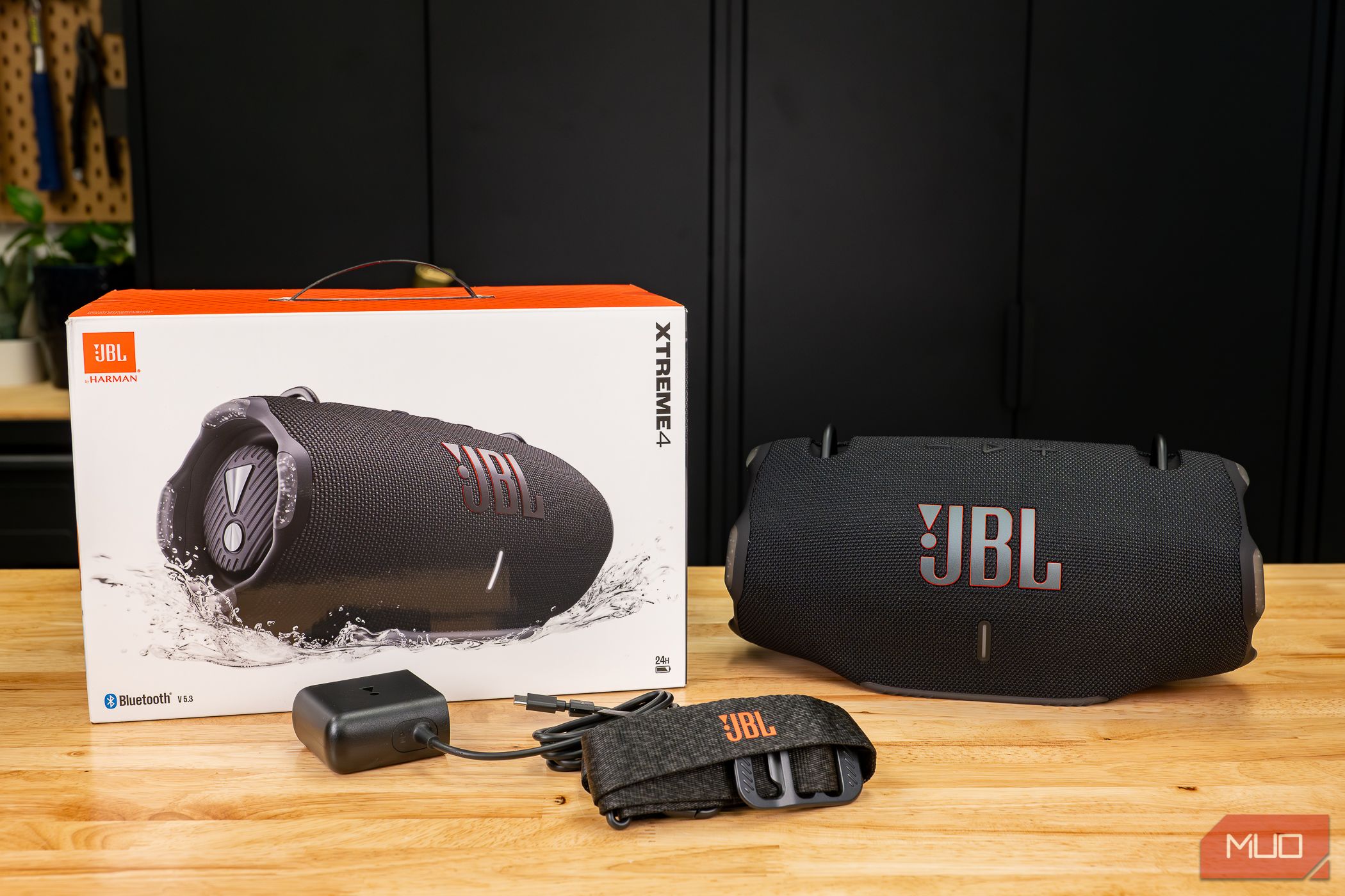 The JBL Xtreme 4 with accessories and box on table