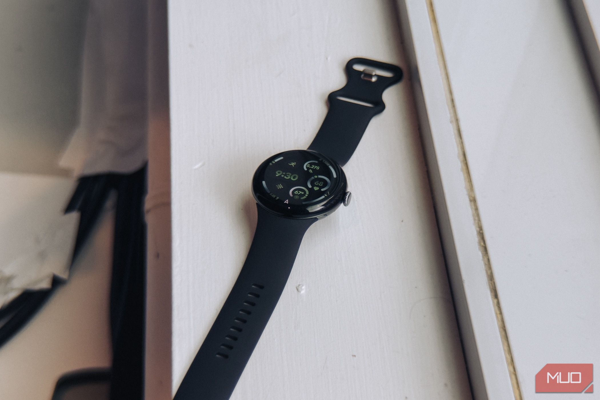 A 45mm Google Pixel Watch 3 next to a window