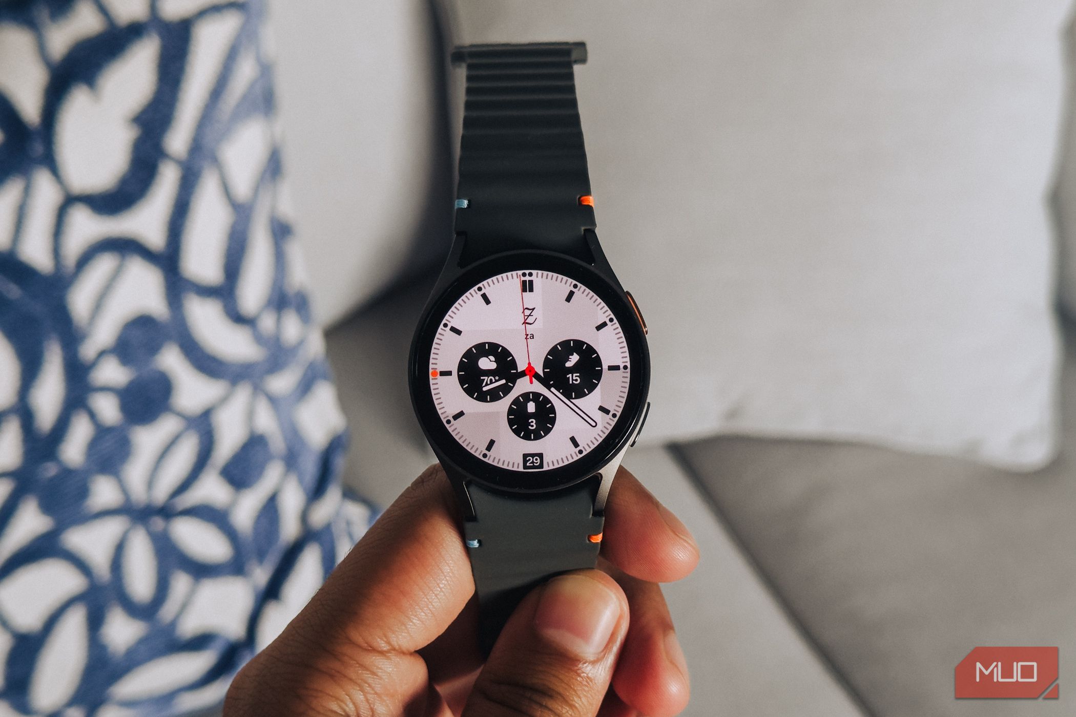 Samsung Galaxy Watch 7 held in-hand by the strap