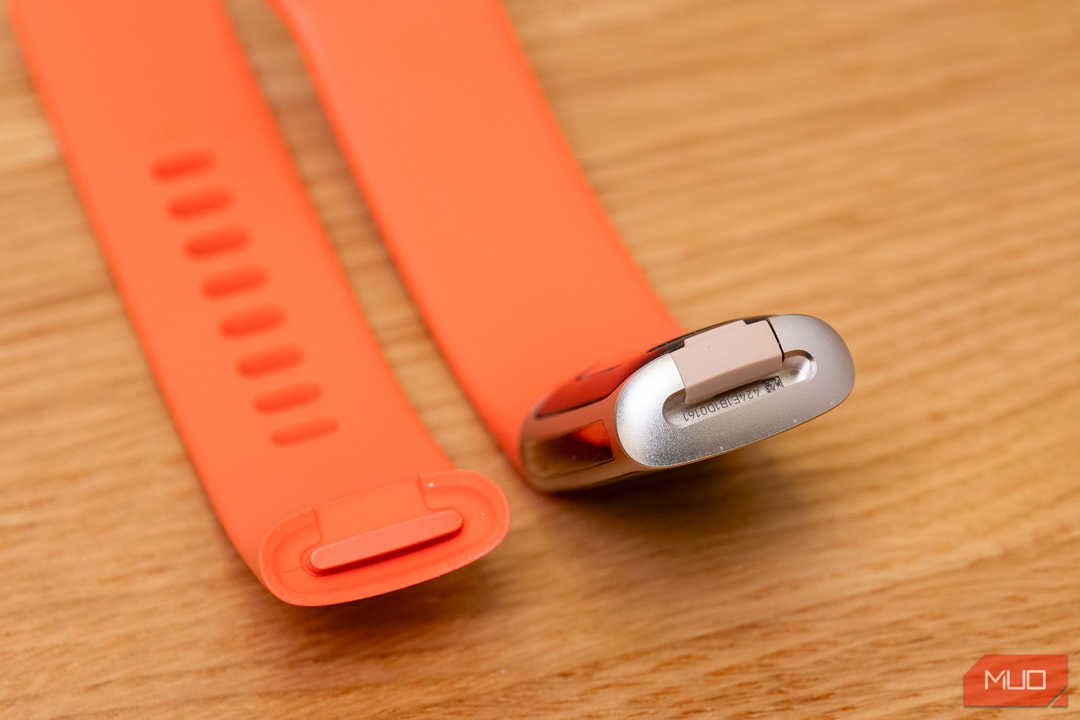 The Fitbit Charge 6 with strap removed on desk