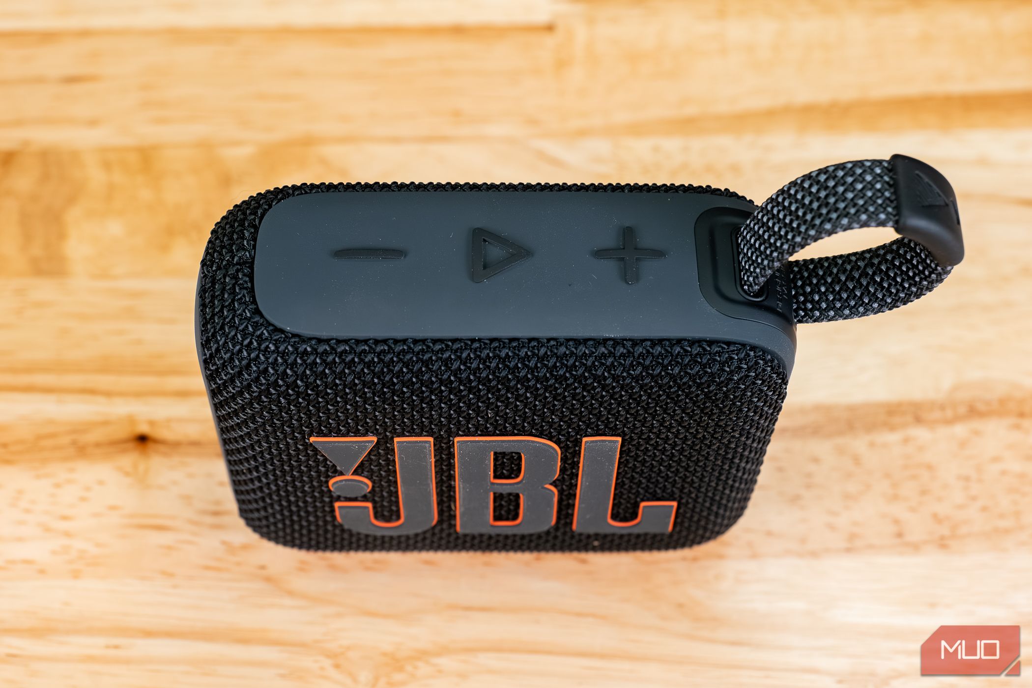 Top buttons on the JBL Go 4 with play button on desk