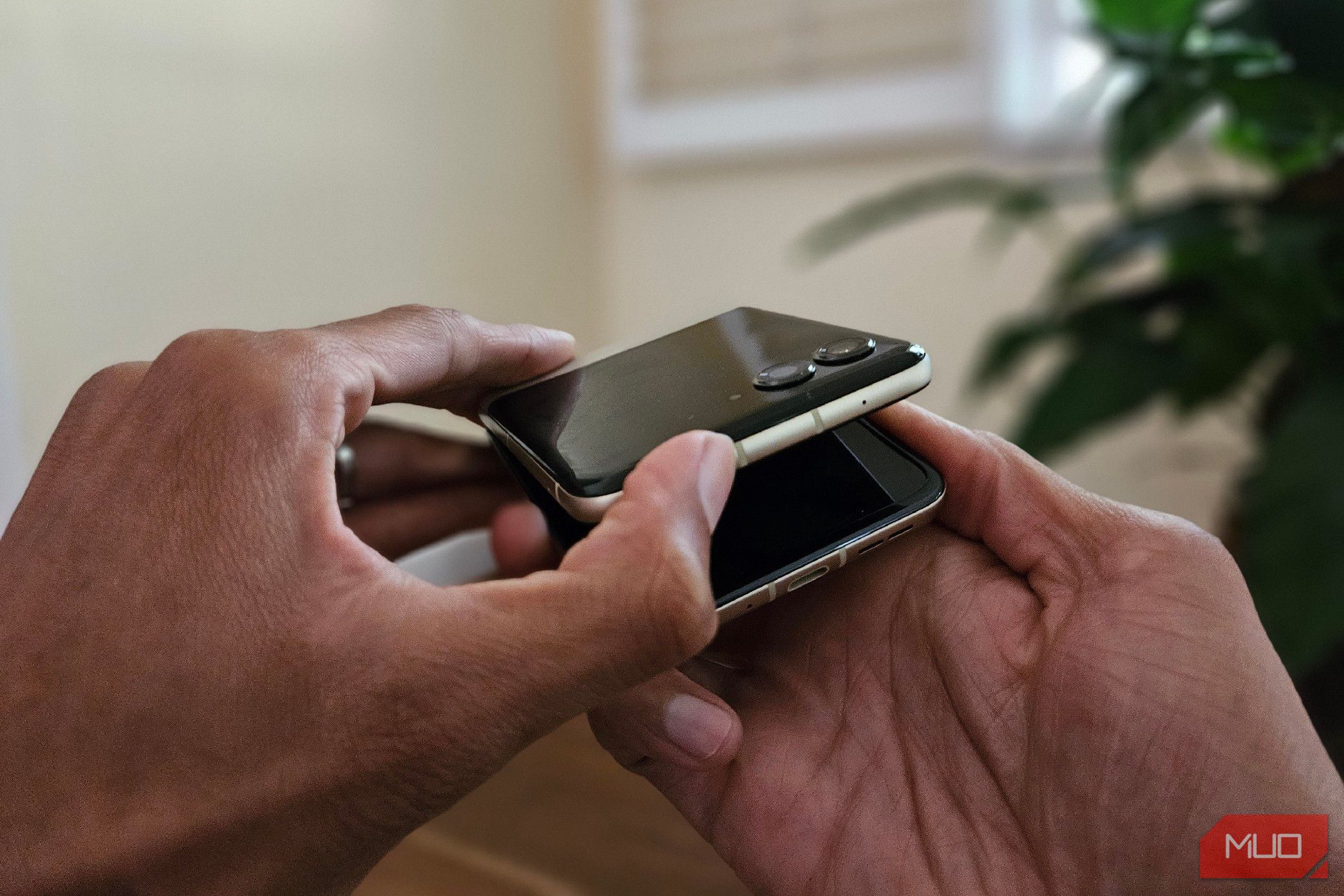 Two hands opening a Motorola Razr 2024.