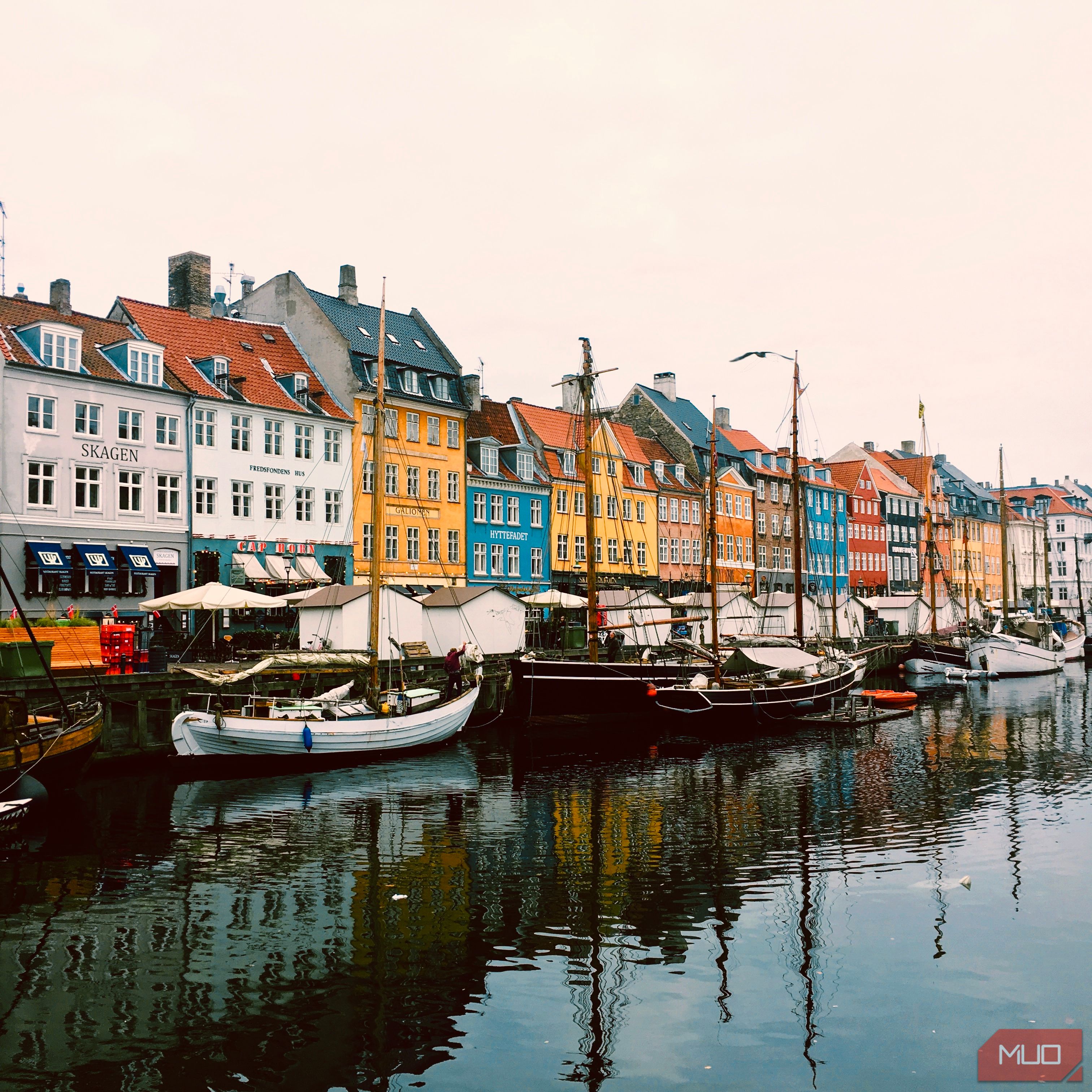 A photo showing a row of colorful buildings on a rainy day