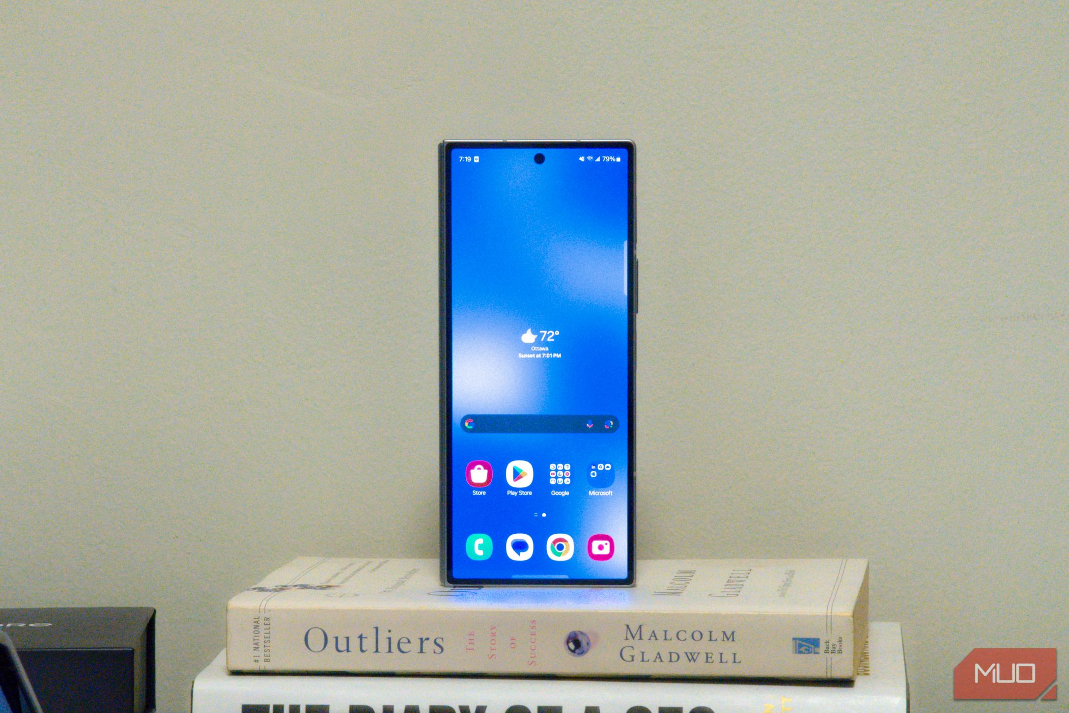 Samsung Galaxy Z Fold 6 cover display on top of a stack of books