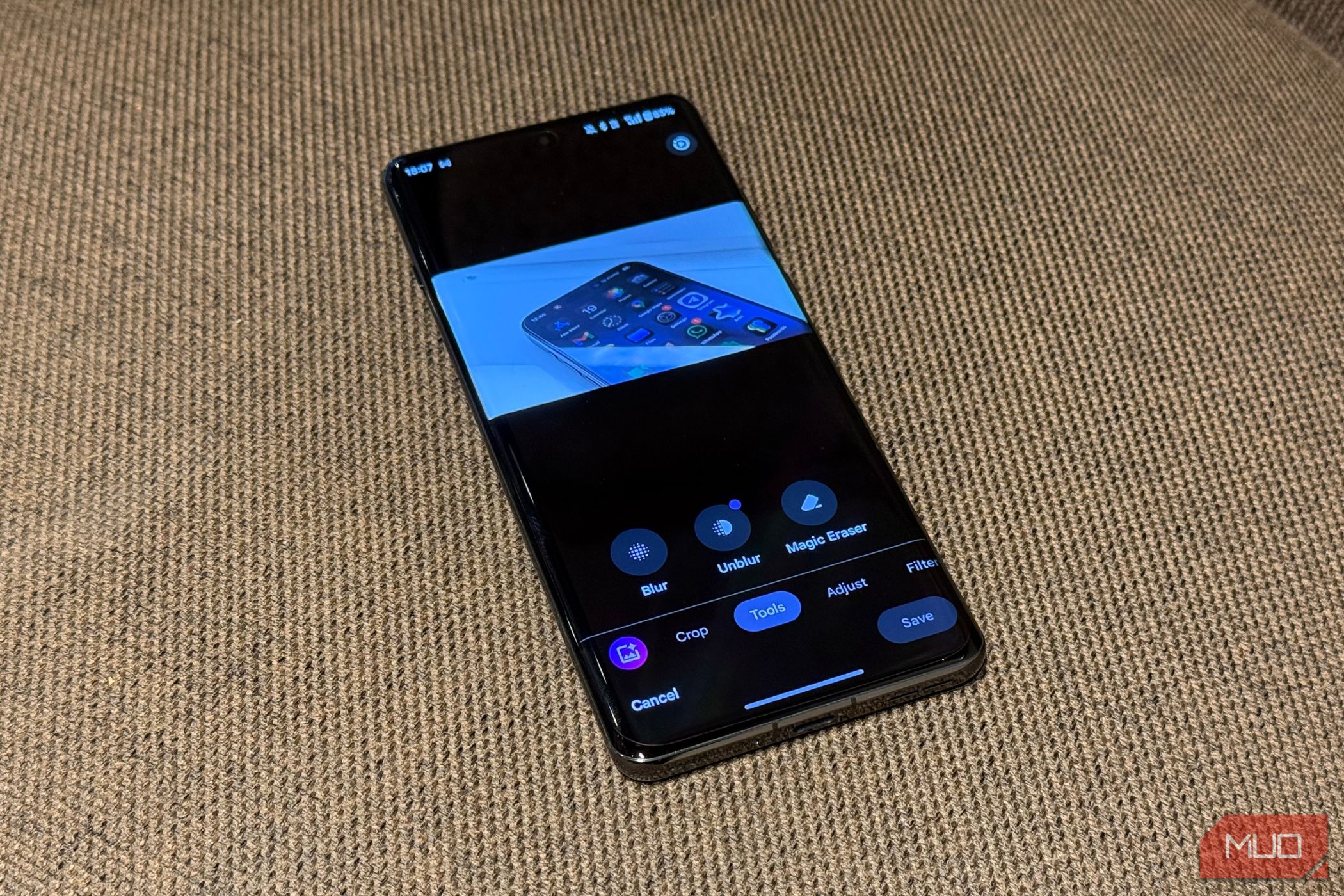 phone kept on a fabric surface with google photos edit menu open showing its tools tab