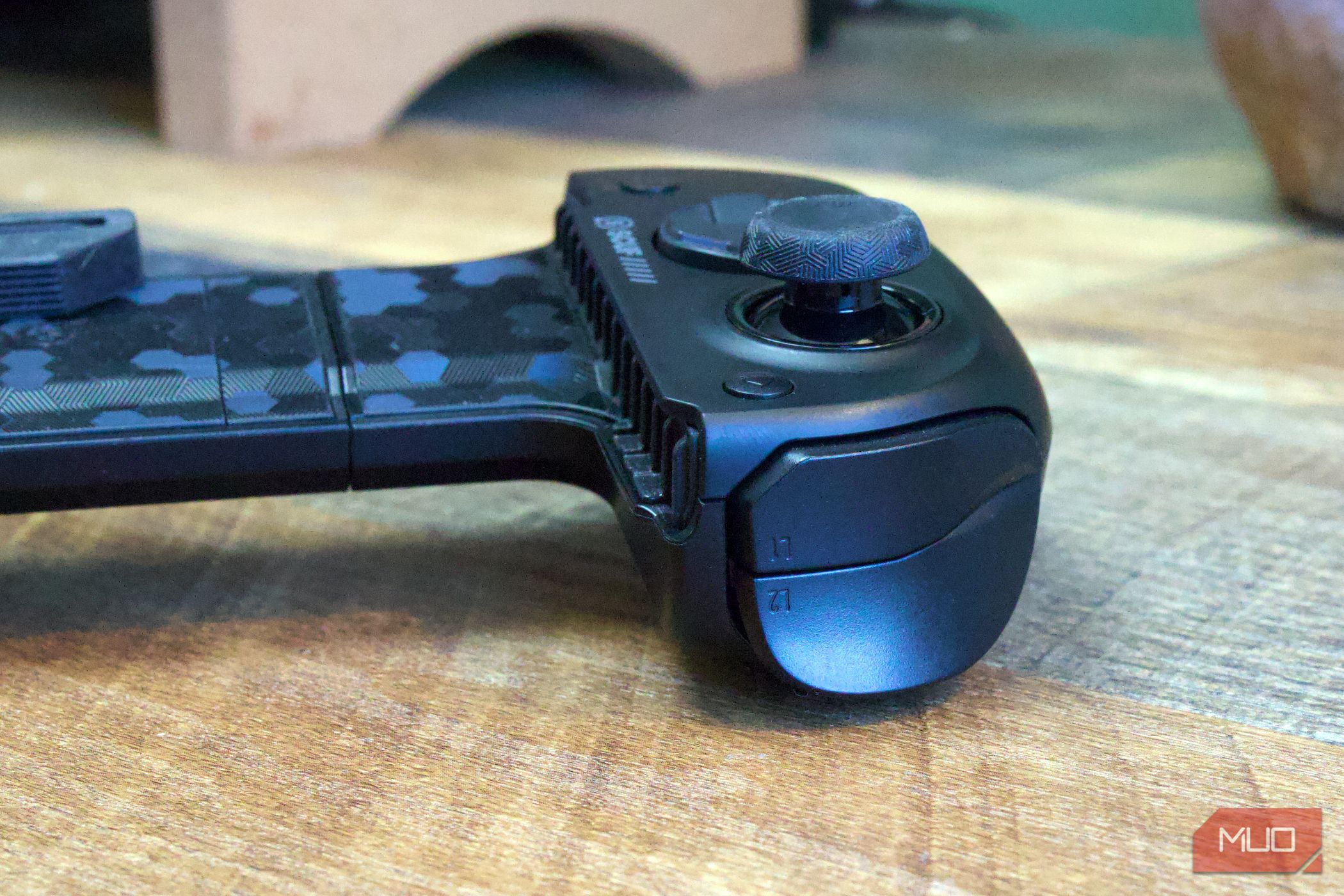 Scuf Nomad Full Sized Trigger and Shoulder buttons close up on brown desk.