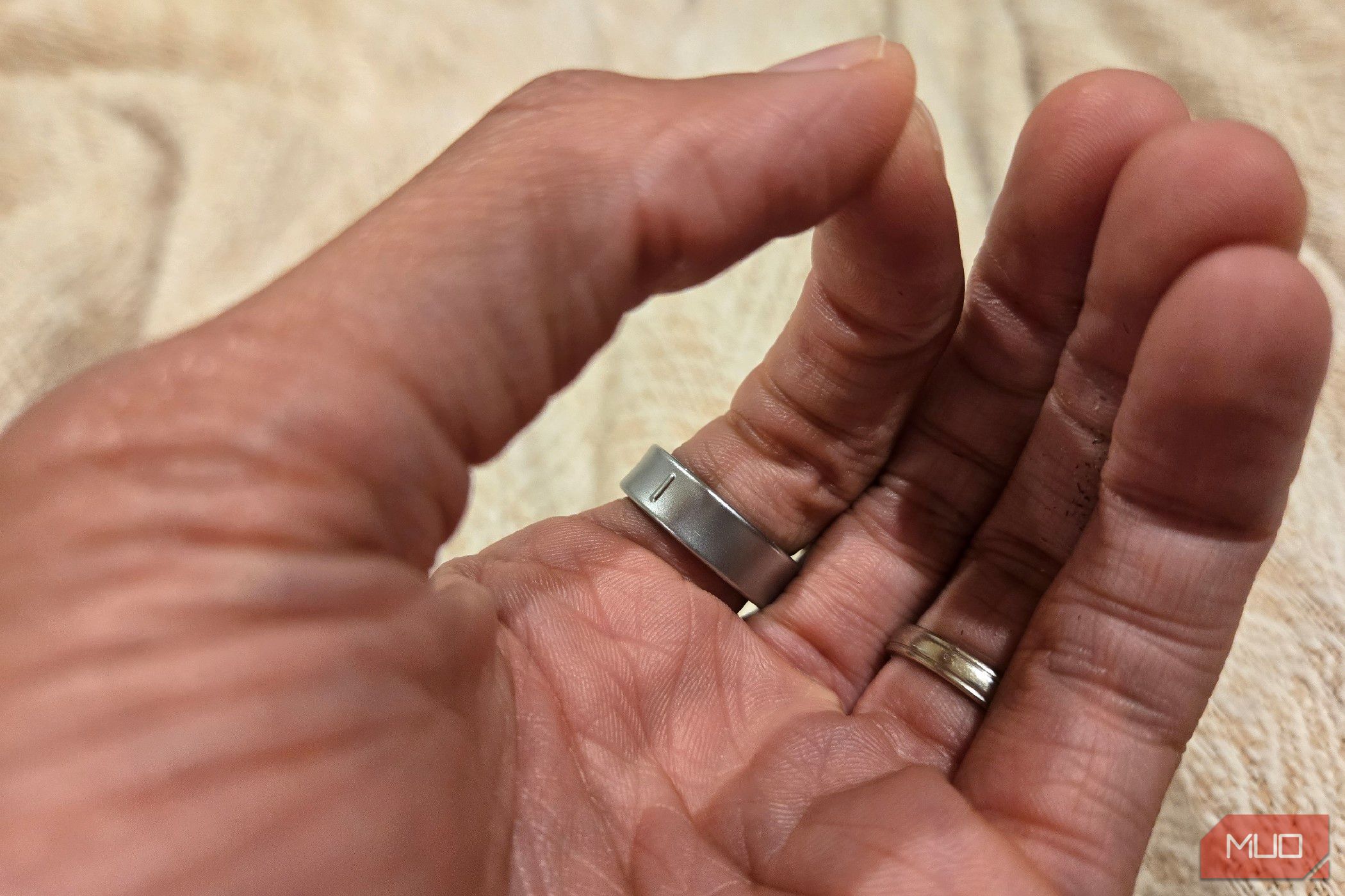 A hand performing a pinch gesture while wearing a Galaxy Ring.