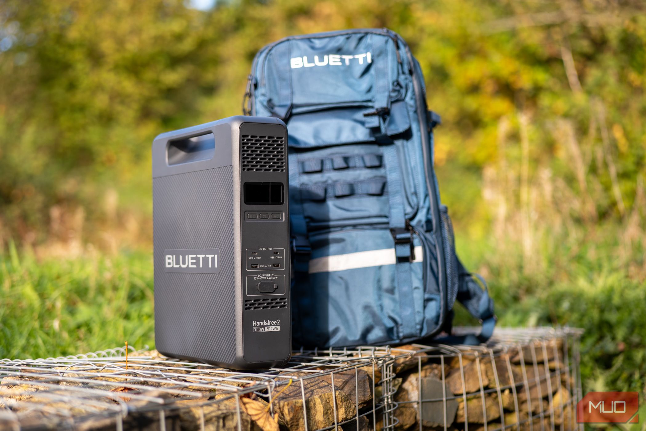 Bluetti Handsfree 2 battery and bag sitting on a wall outside.