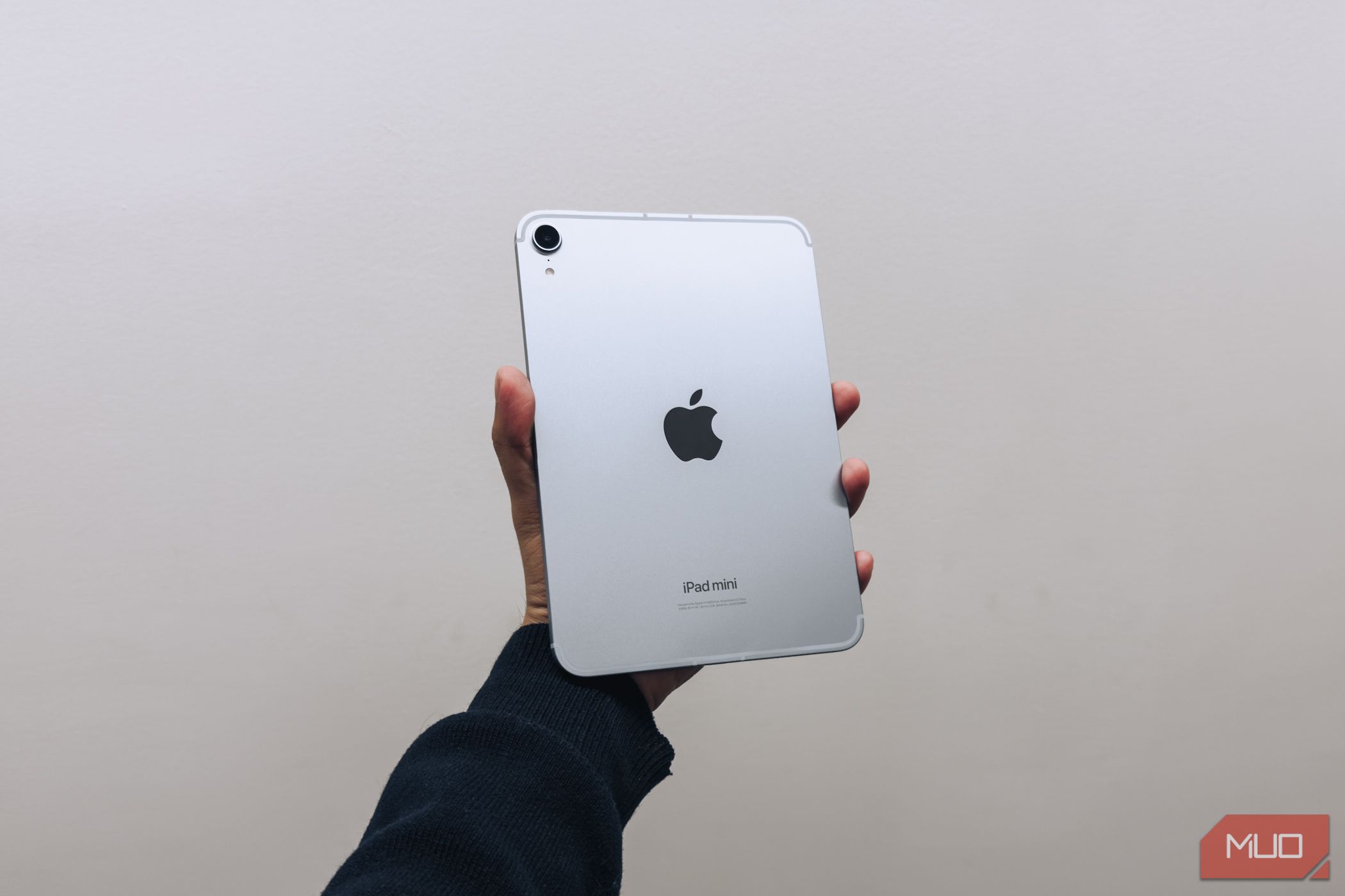 iPad mini (A17 Pro) in hand against white background