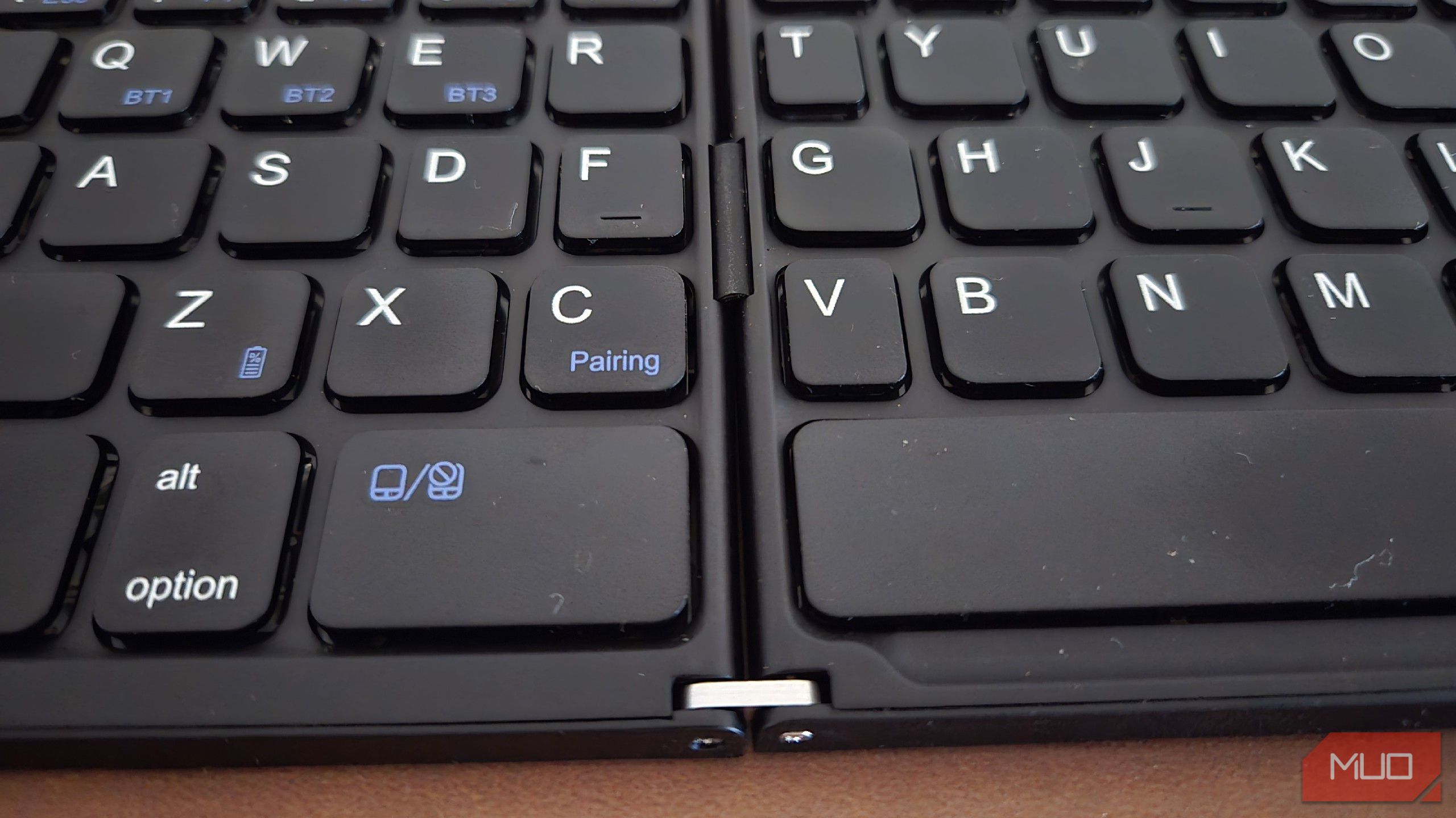 A close-up of the hinge on a folding Bluetooth keyboard.