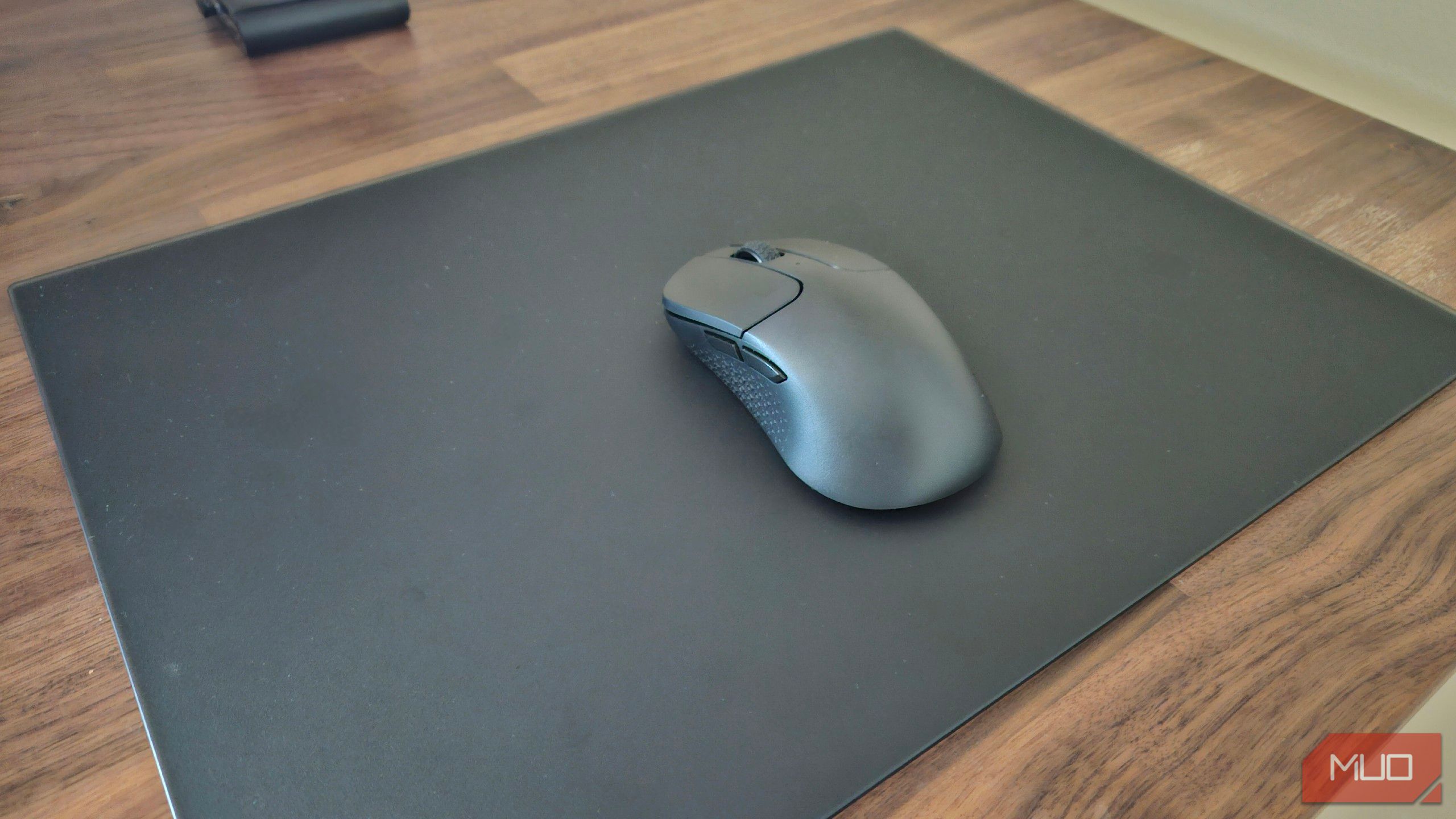 A Bluetooth mouse on a tempered glass mousepad