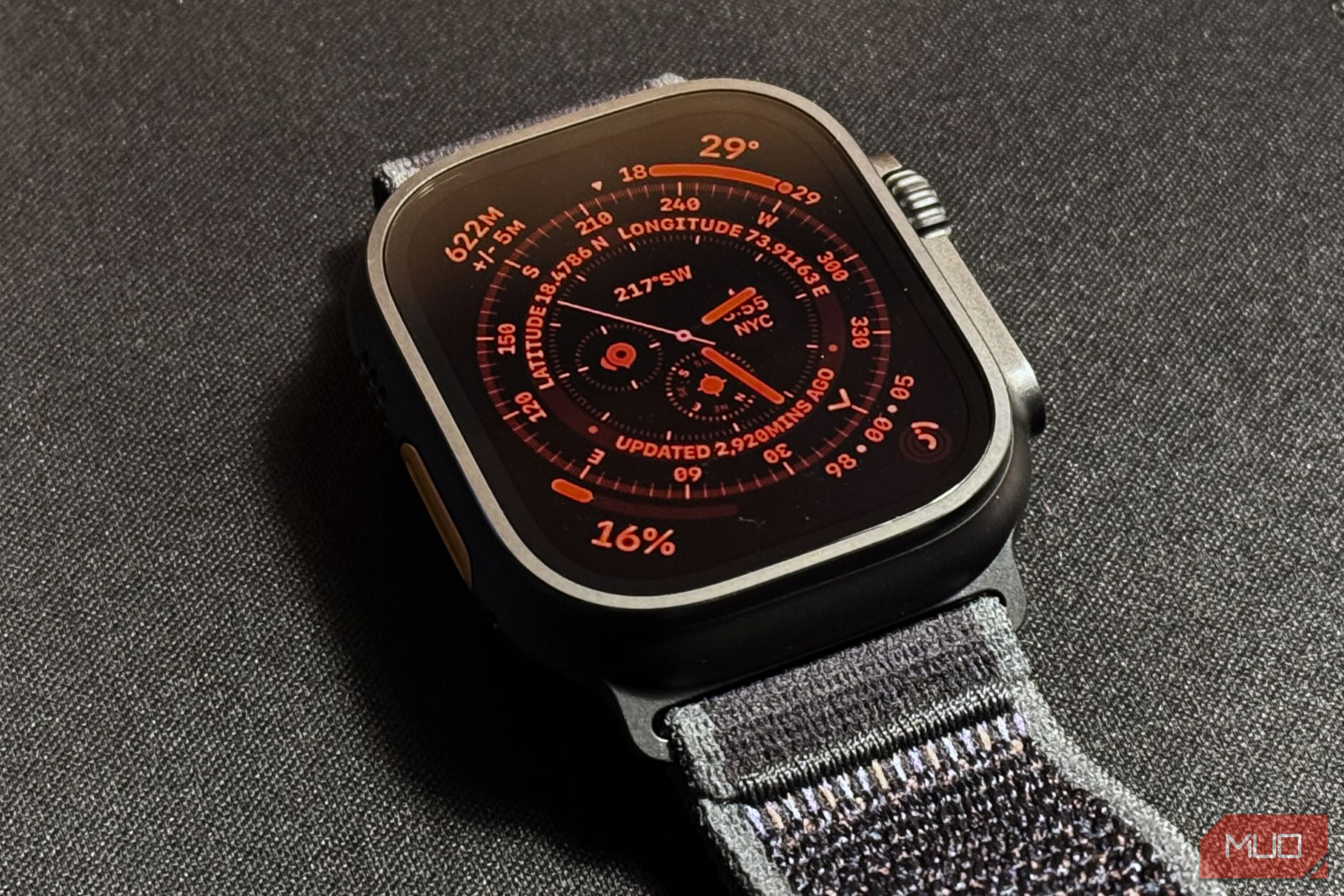 Apple Watch Ultra 2 with active night mode watch face kept on a black mat