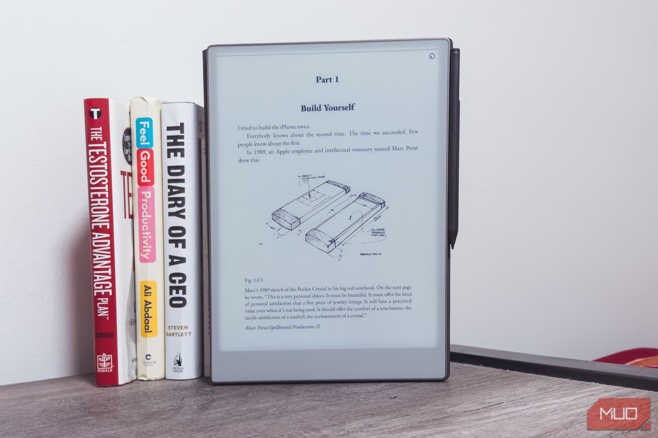 reMarkable Paper Pro next to books on a wooden table.