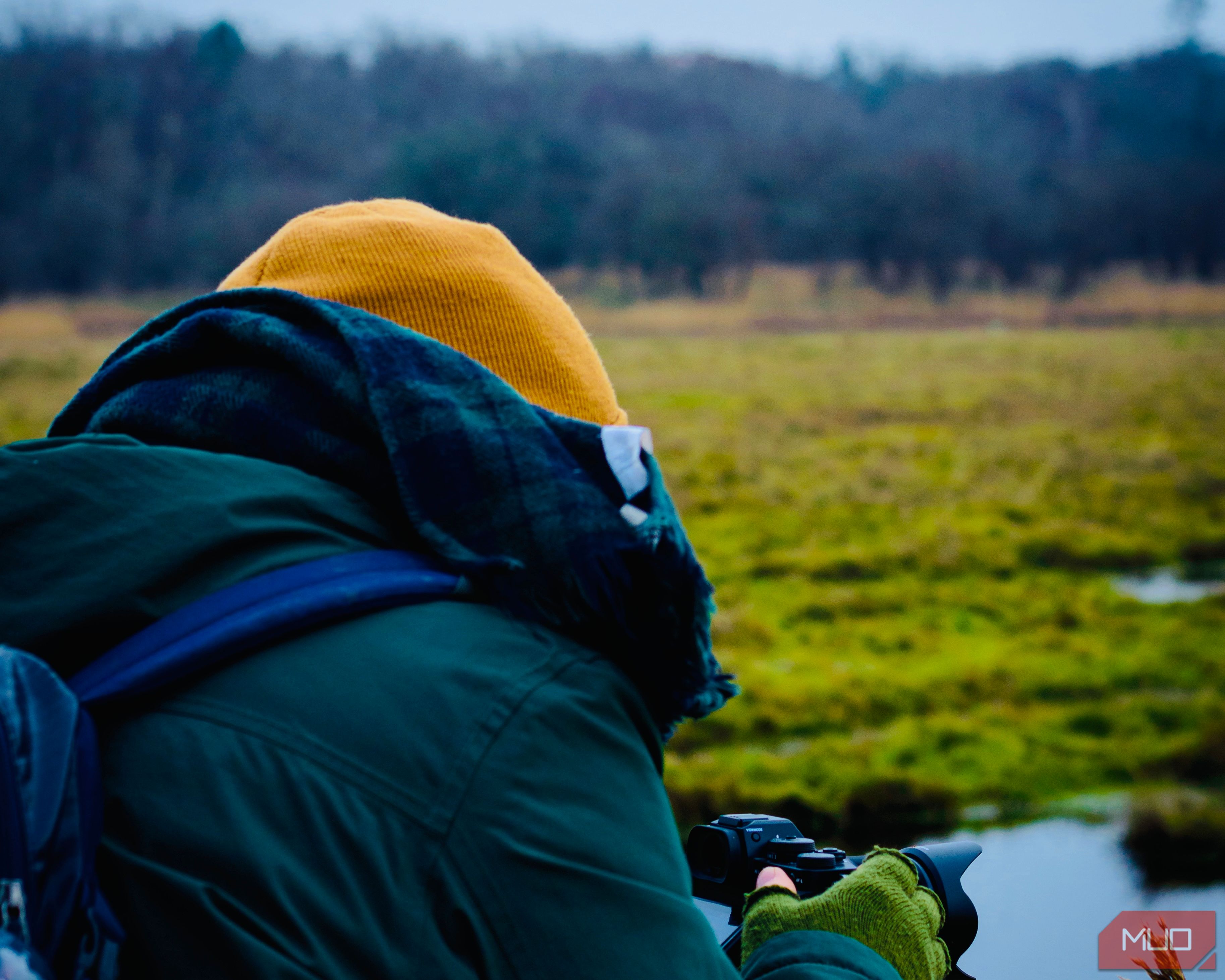 An image of a person taking pictures on a winter hike